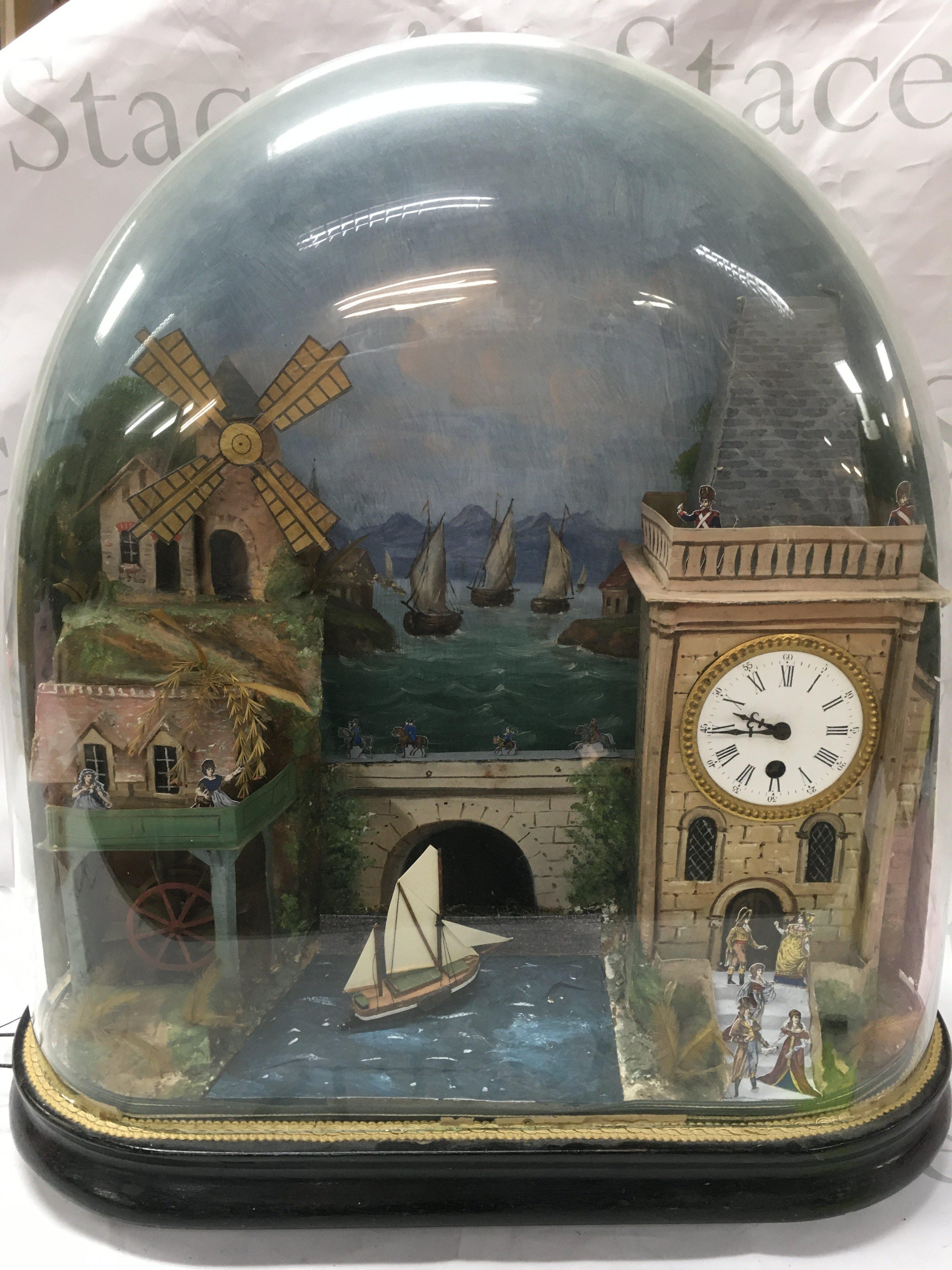 An automaton rocking ship, watermill windmill , moving town folk figures under dome . Seen working . Approximately 50cm wide 54cm tall