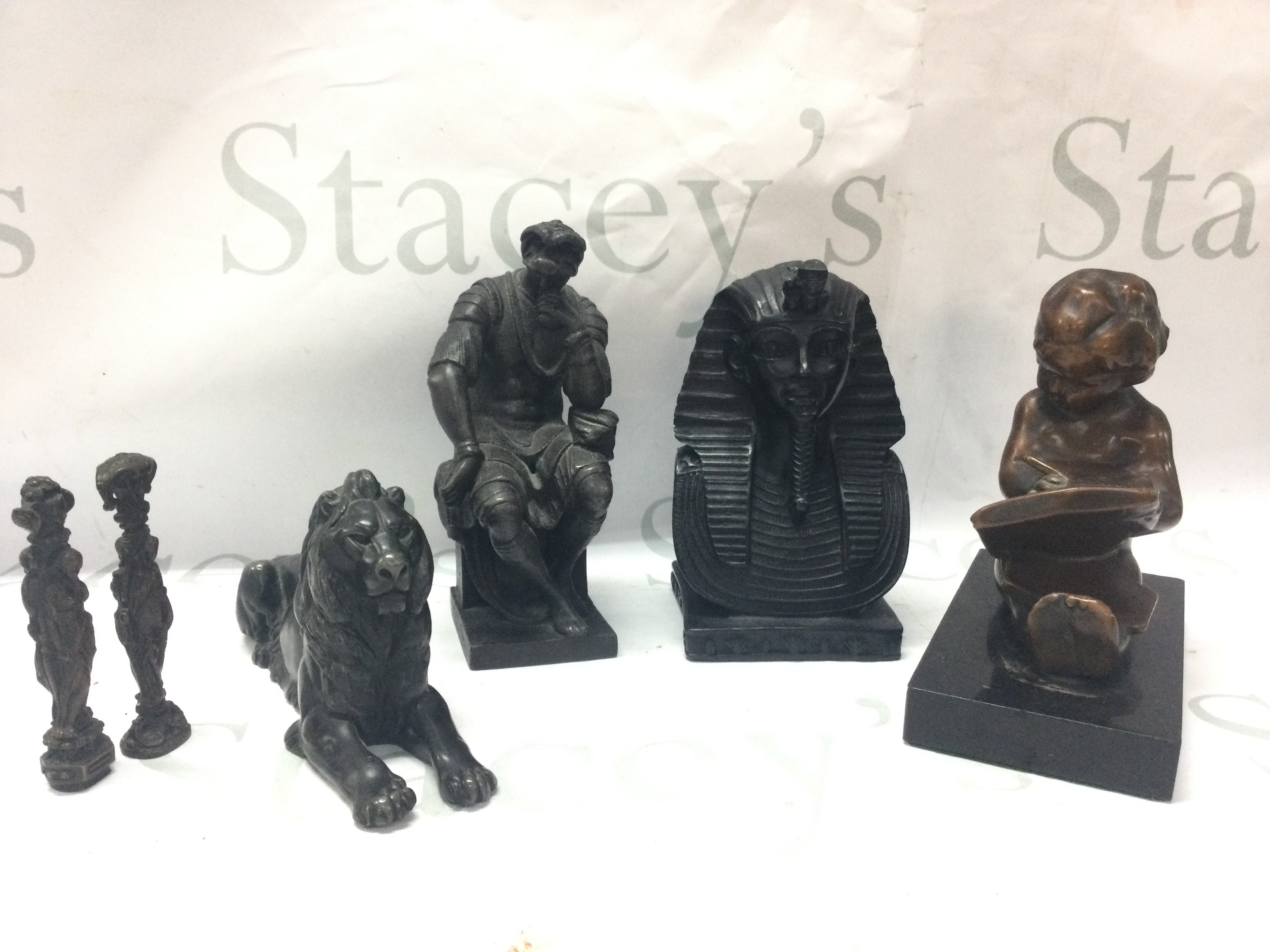 A Tutankhamen bust, lion figure, child reading book , Lorenzo di Piero de Medici figure, bronze figures desk seals. Postage category C