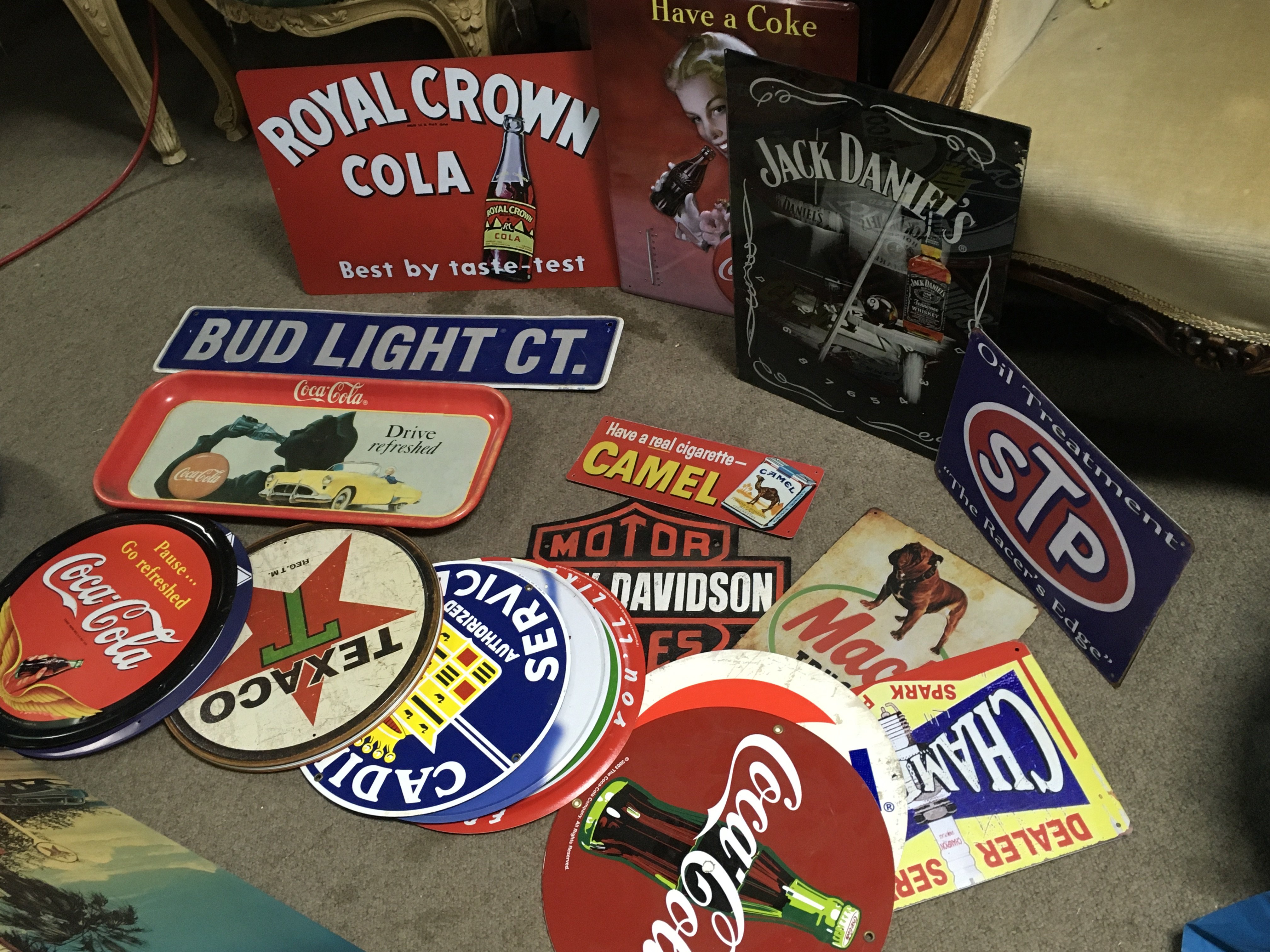 A Collection of vintage metal advertising signs including Harley Davidson, Jack Daniels, Coca Cola , Coca Cola tray , McDonalds, Cadillac, lucky strike etc . Postage category C