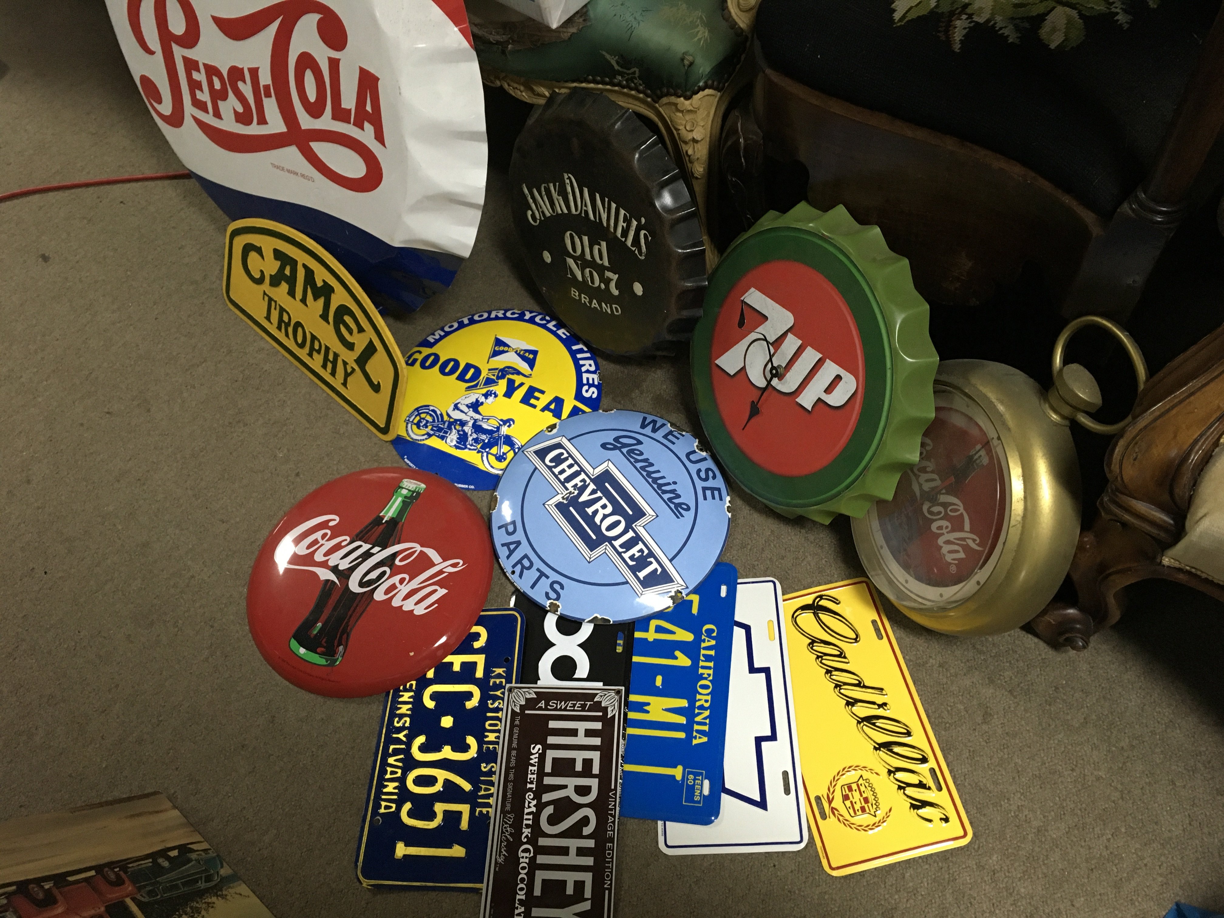 A Collection of vintage metal advertising signs including a large Pepsi bottle cap sign, camel, good year, Jack Daniels etc. this lot cannot be posted