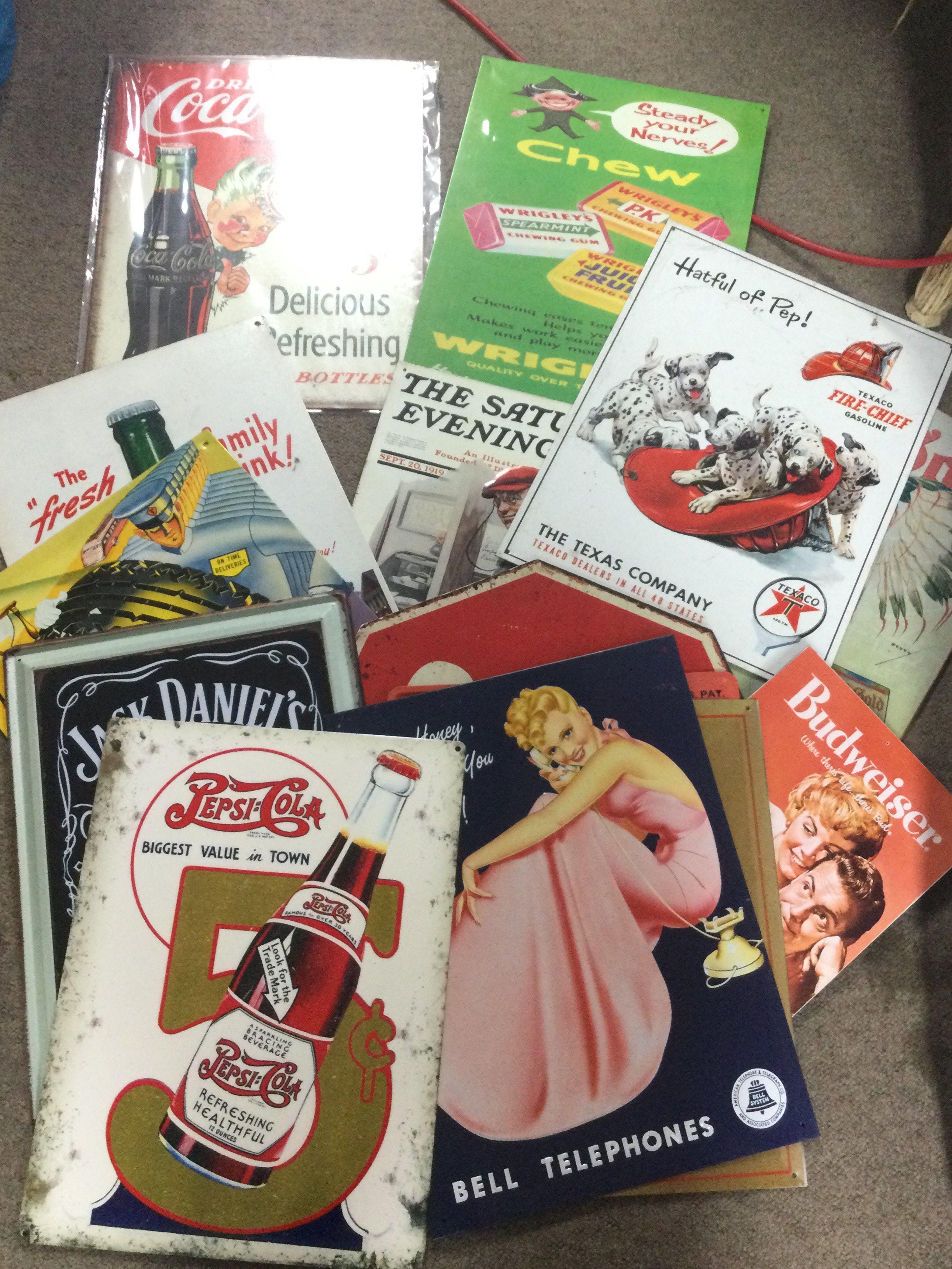 A collection of metal advertising signs including Ford , Winston cigarettes, Coca Cola etc. postage cat C