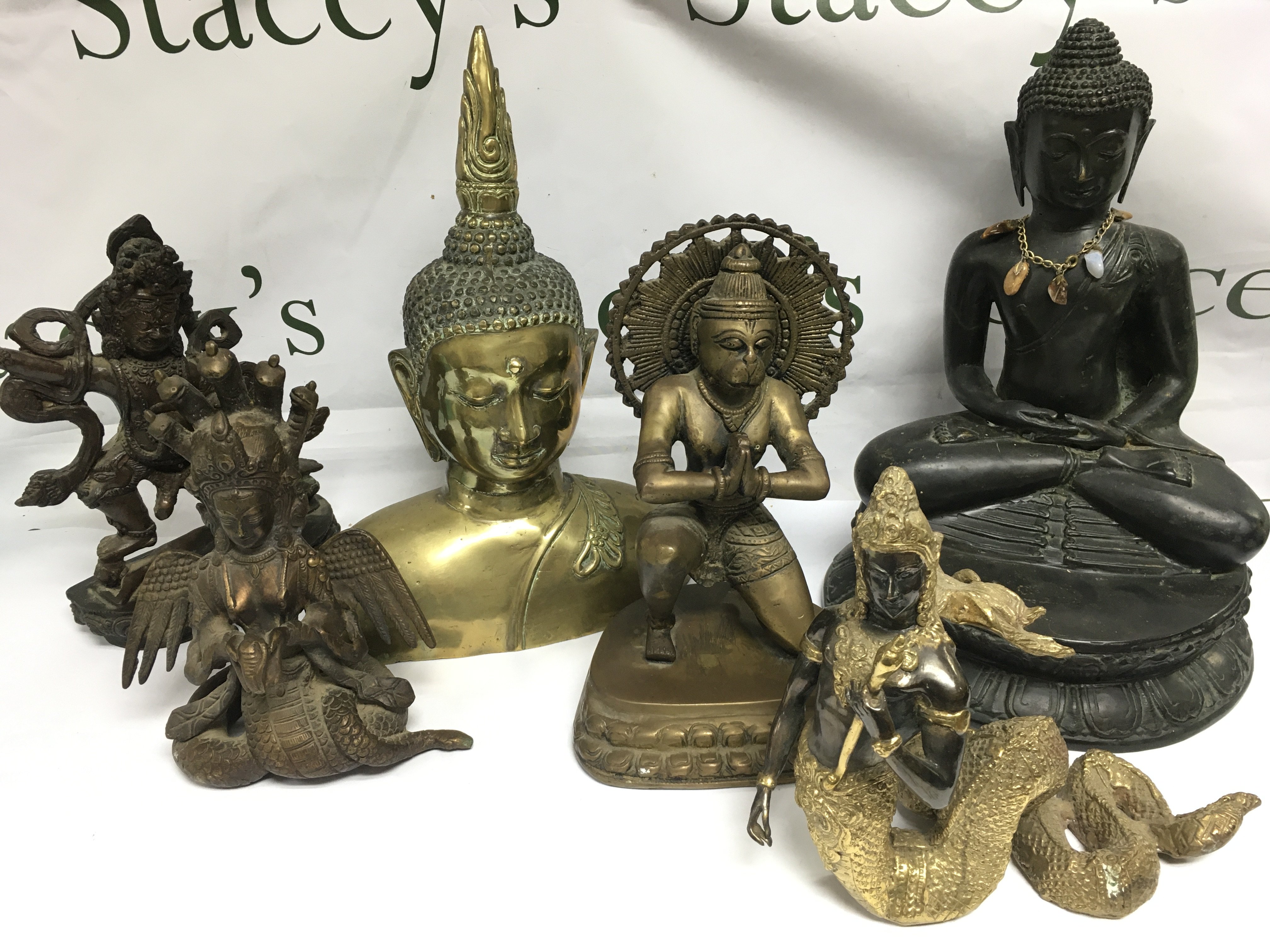 Six brass and spelter figures of Indian deities and Buddha. Shipping category D.