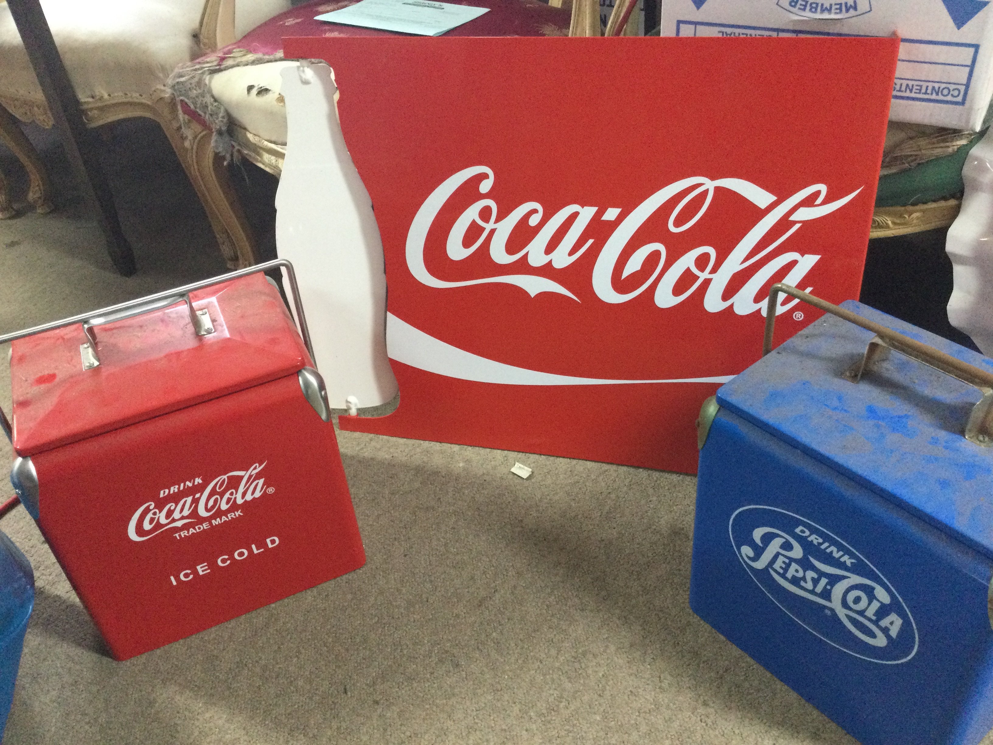 A vintage Coca Cola spinning bottle sign, Coca Cola and Pepsi cooler boxes. 32cm tall. Sign 65cm wide 54cm tall. This lot cannot be posted