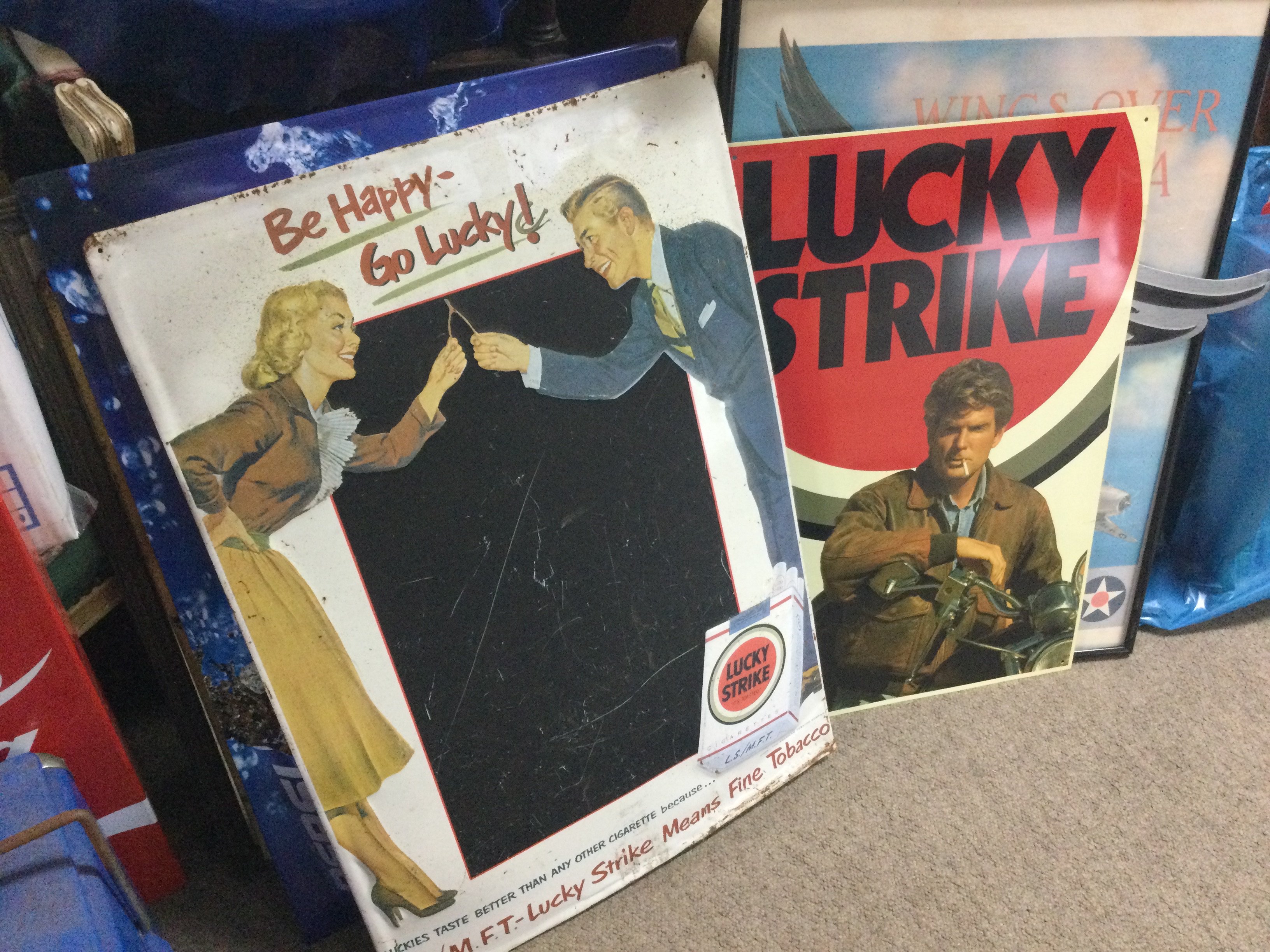 A collection of vintage advertising signs including a vintage enamel lucky strike be happy to lucky sign , Camel cigarettes mirror advertising sign, metal signs including Pepsi, Budweiser etc . This lot cannot be posted