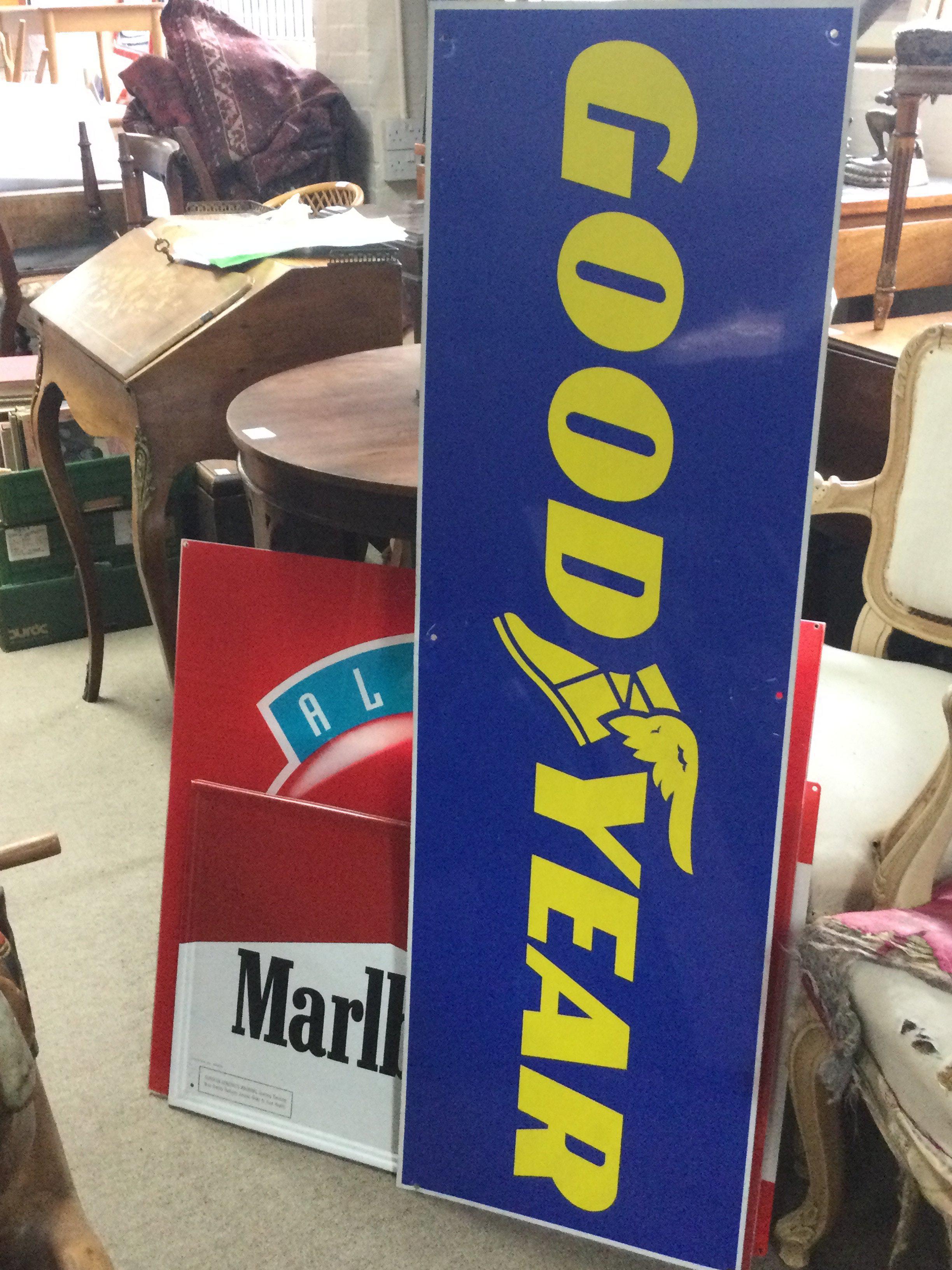 A collection of vintage advertising signs including Goodyear, Marlboro, Indian Roadking, Always Coca Cola. This lot cannot be posted