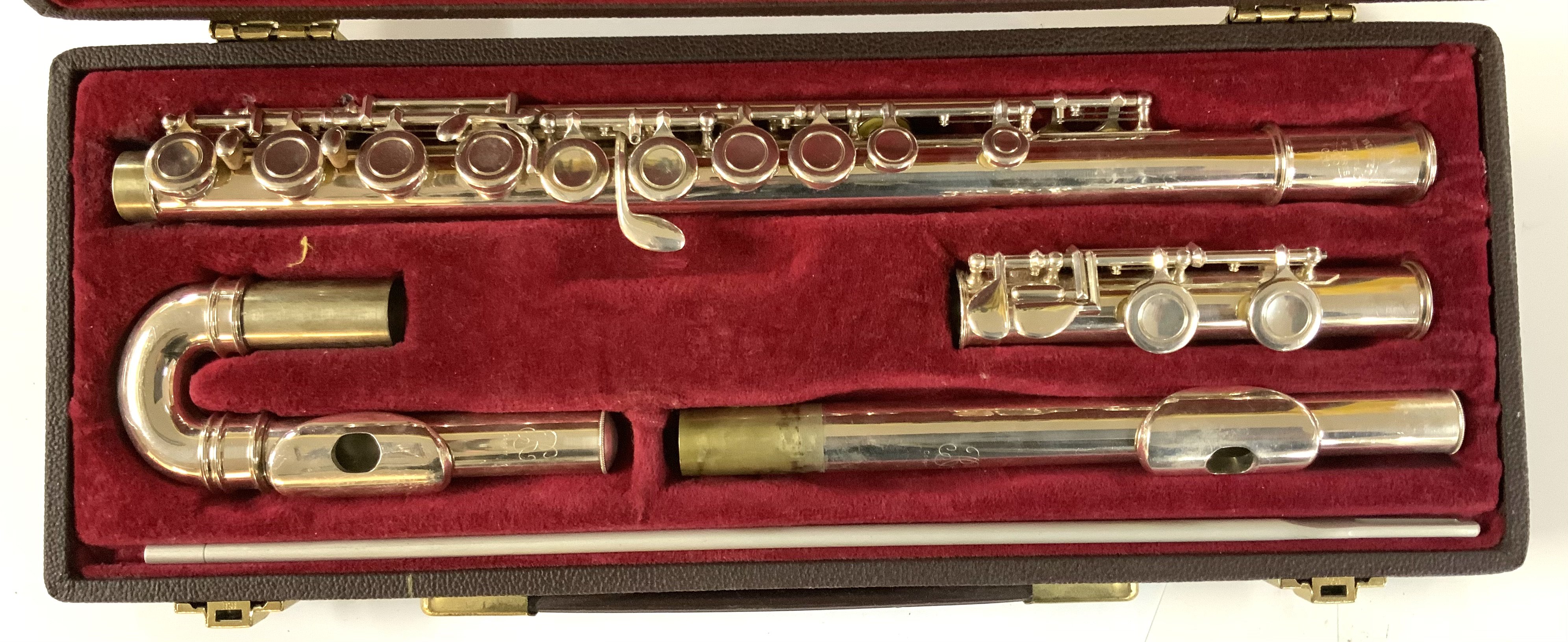 A cased Buffett and Crompton flute with curved and straight heads. Chrome plated.