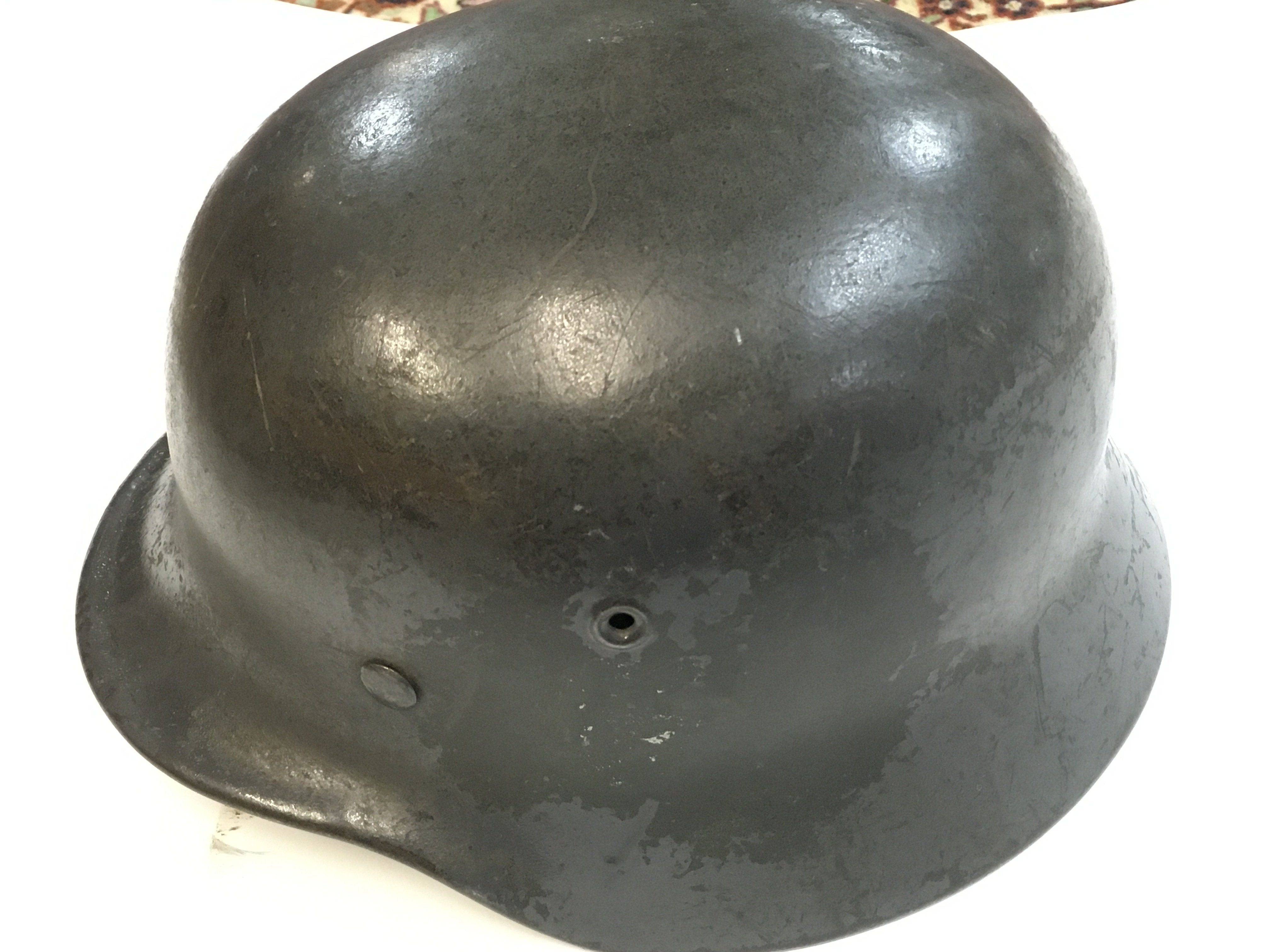 A WW2 German helmet with remnants of a decal. Postage cat c