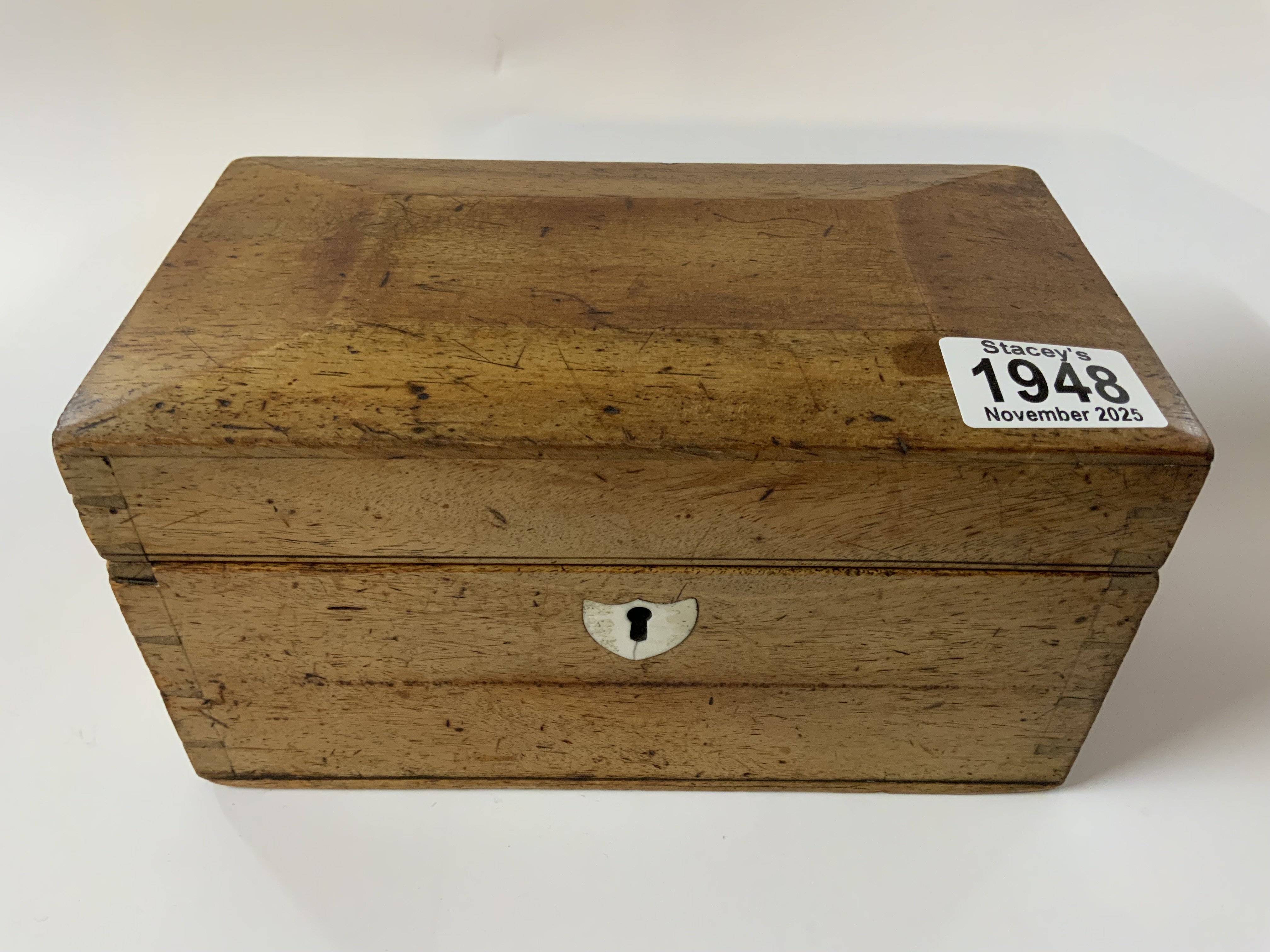 A small Victorian walnut tea caddy together with a mixed collection of vintage marbles.