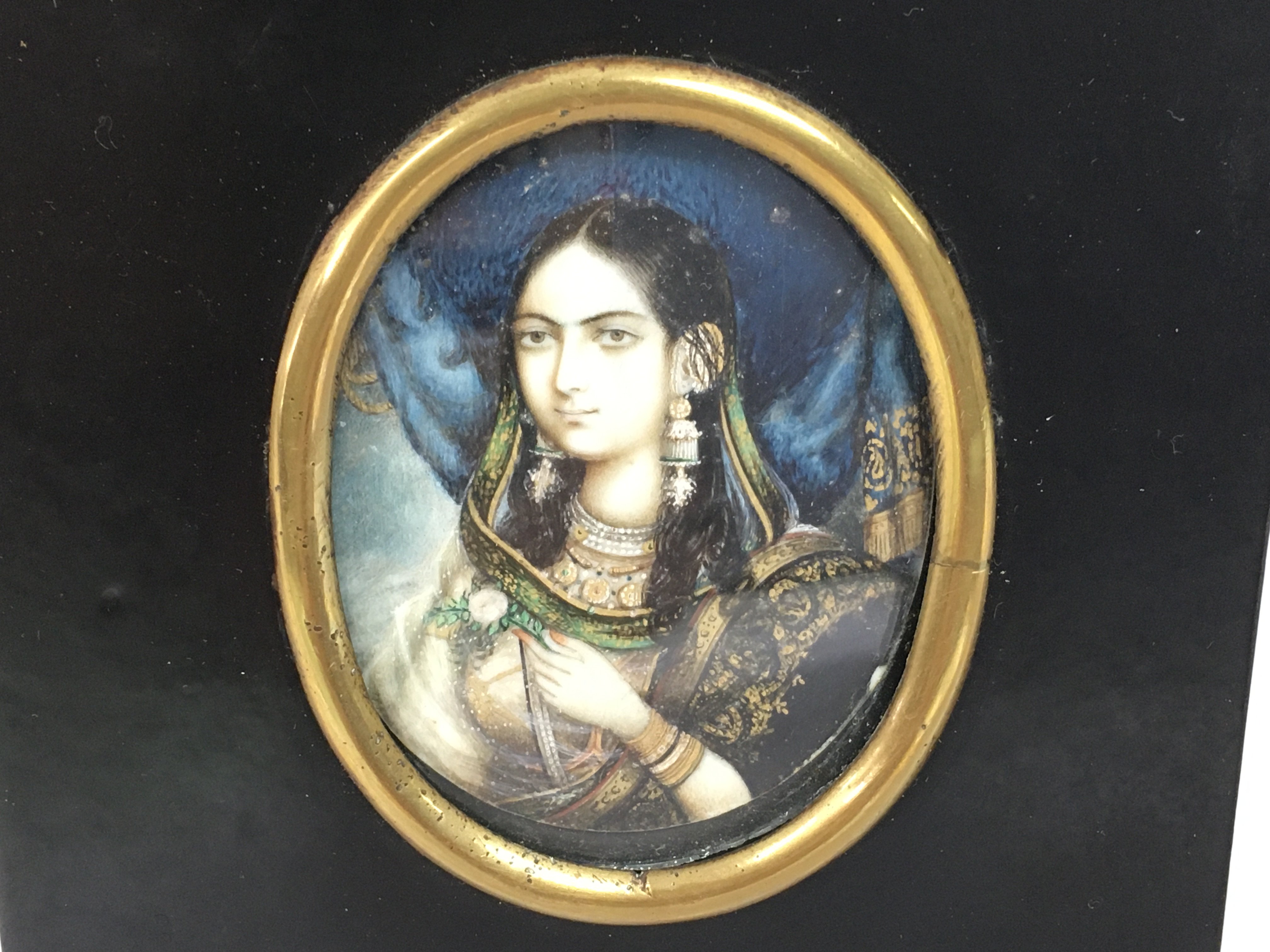 A 19th century ebonised, framed portrait miniature depicting an Indian lady in traditional dress. 10cm x 14cm. NO RESERVE