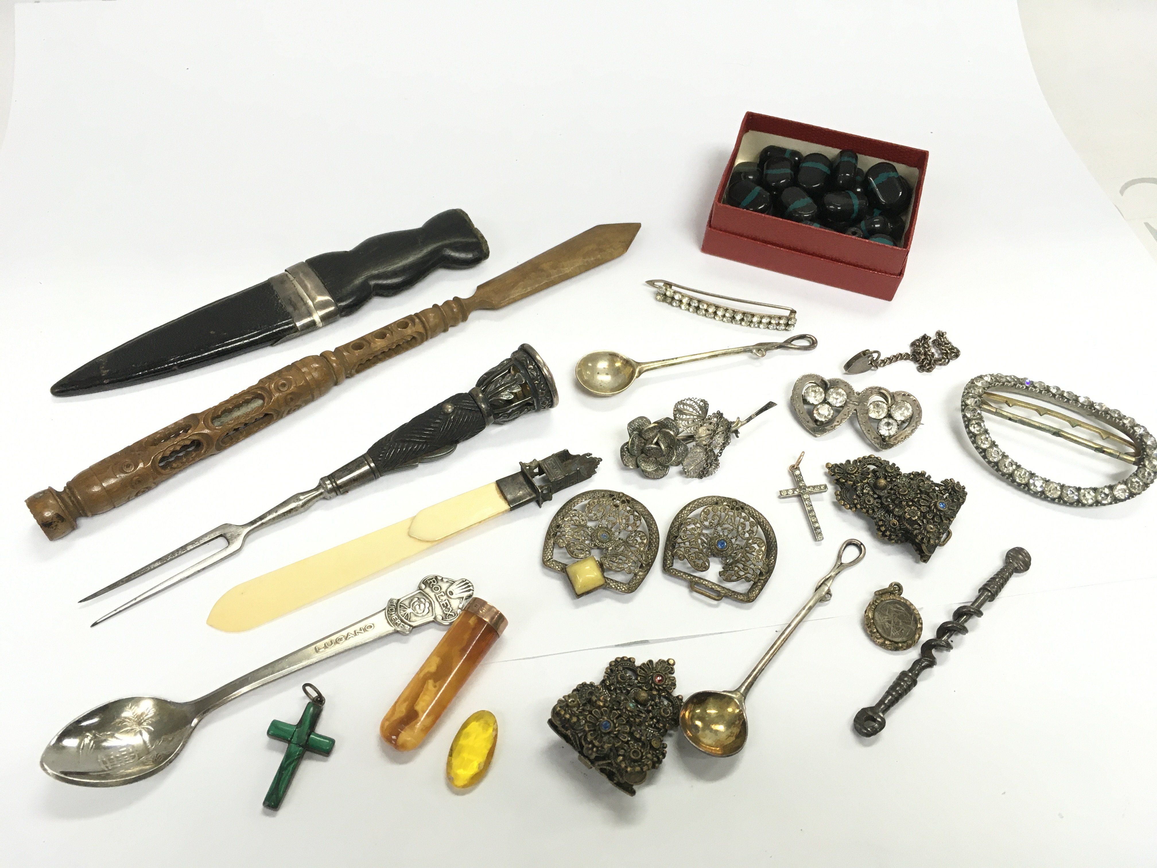 A mixed lot of small items of virtue including brooches, belt buckle , Stanhope style wooden pen knife etc. postage category B