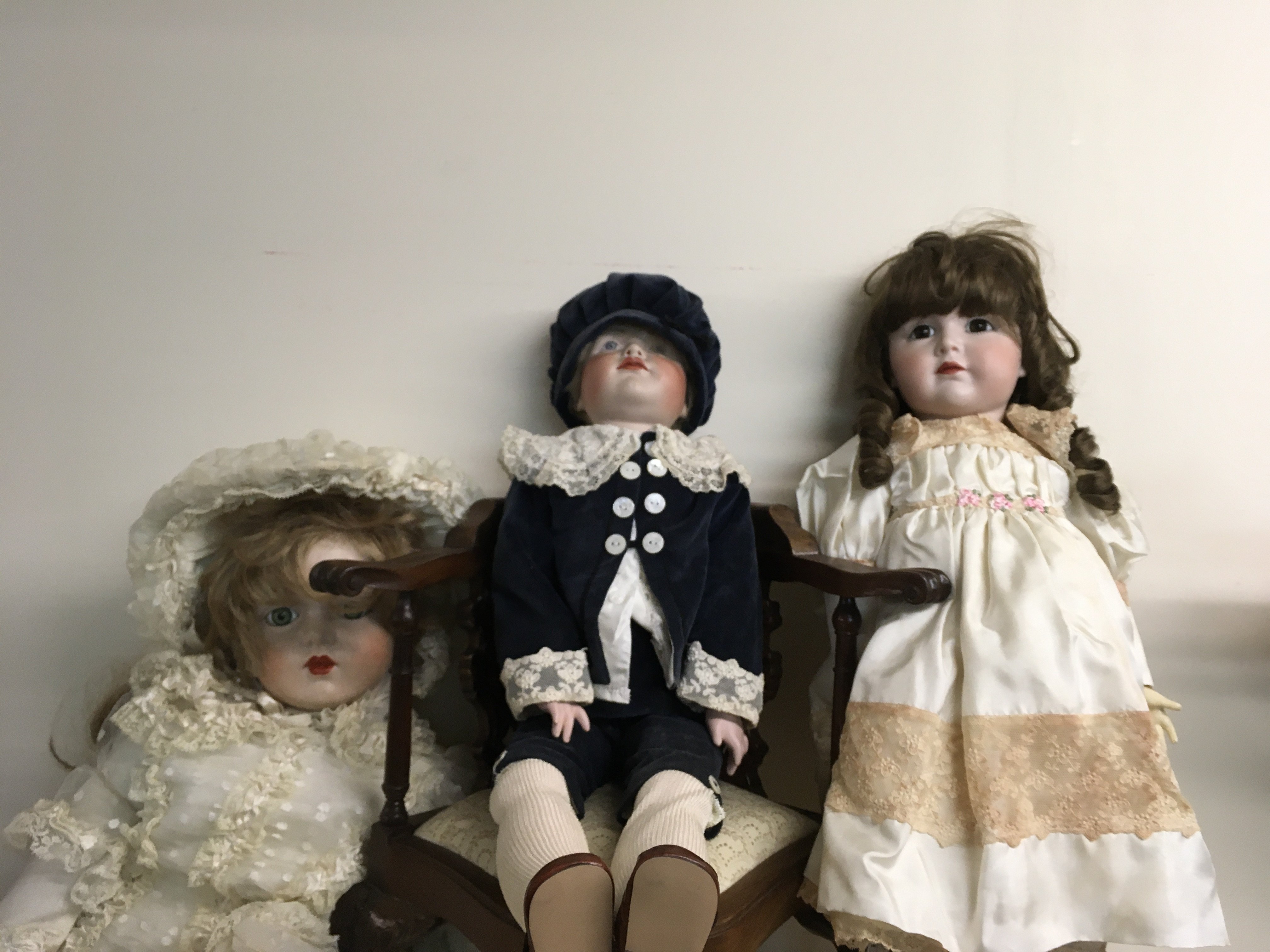 Three Victorian style dolls together with a reproduction dolls corner chair (No reserve) .