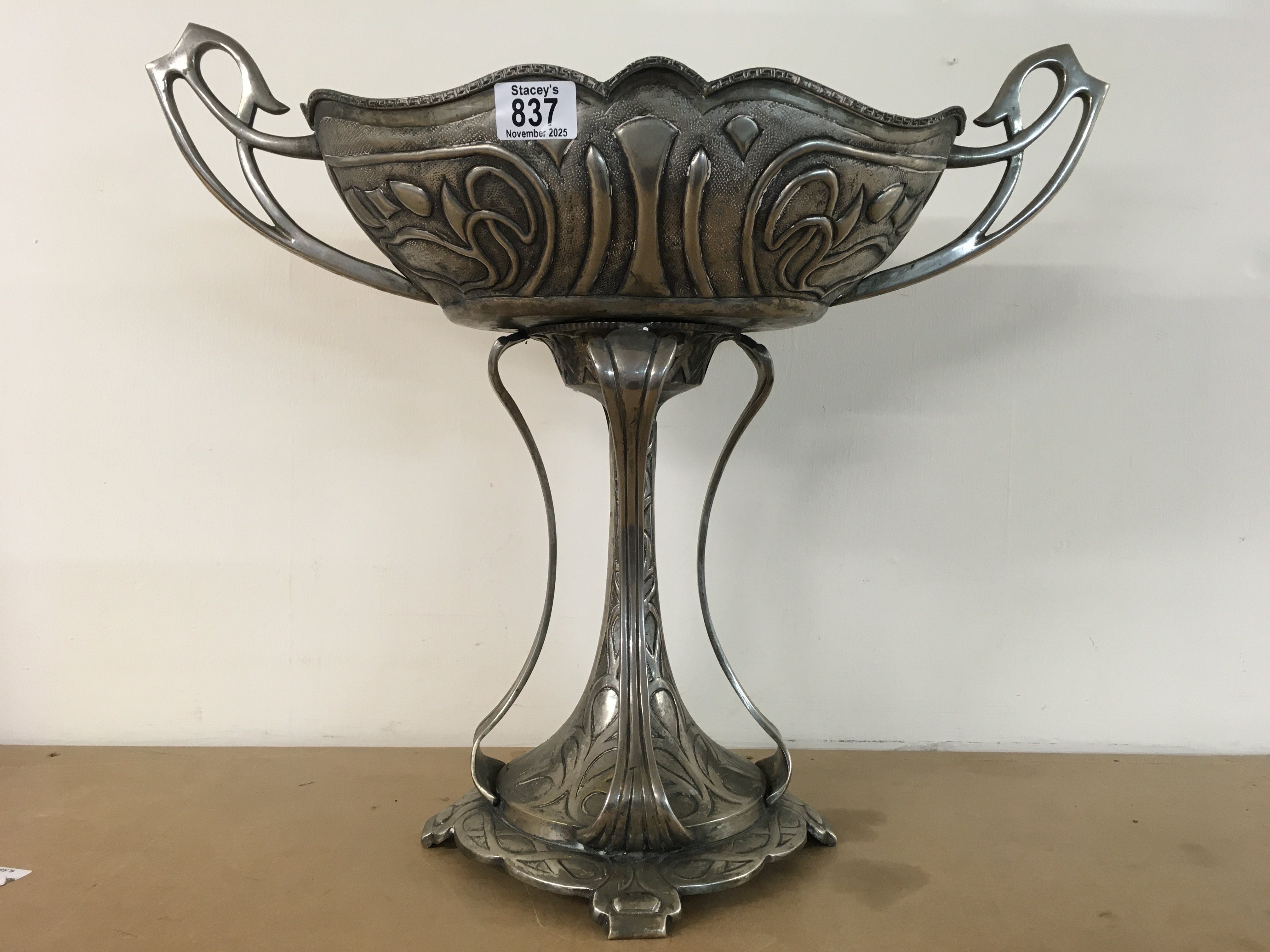 An Art Nouveau style silver plated jardiniere with stylised twin handles and traditional stylised design. 46cm height x 54cm x 25cm