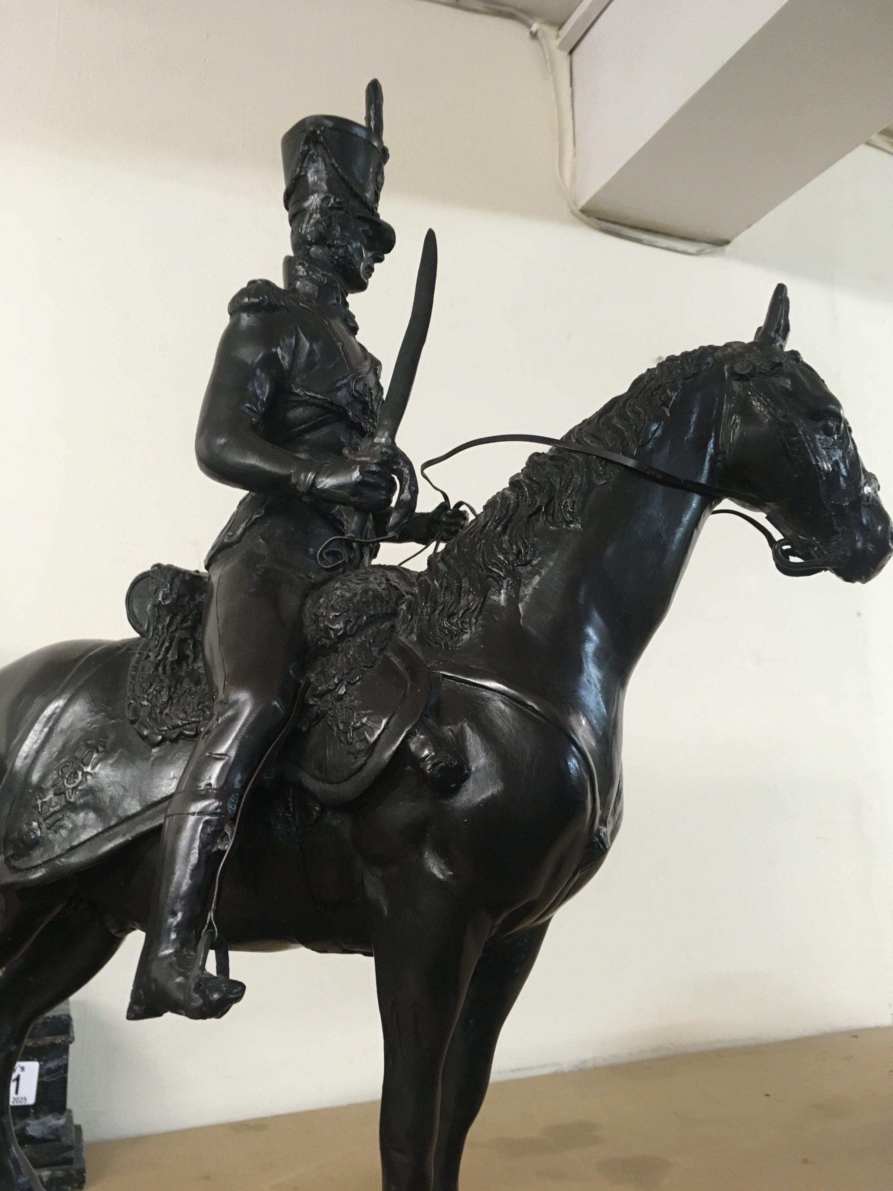A bronzed model in the form of a Prussian Hussar on a marble base . 53 cm .