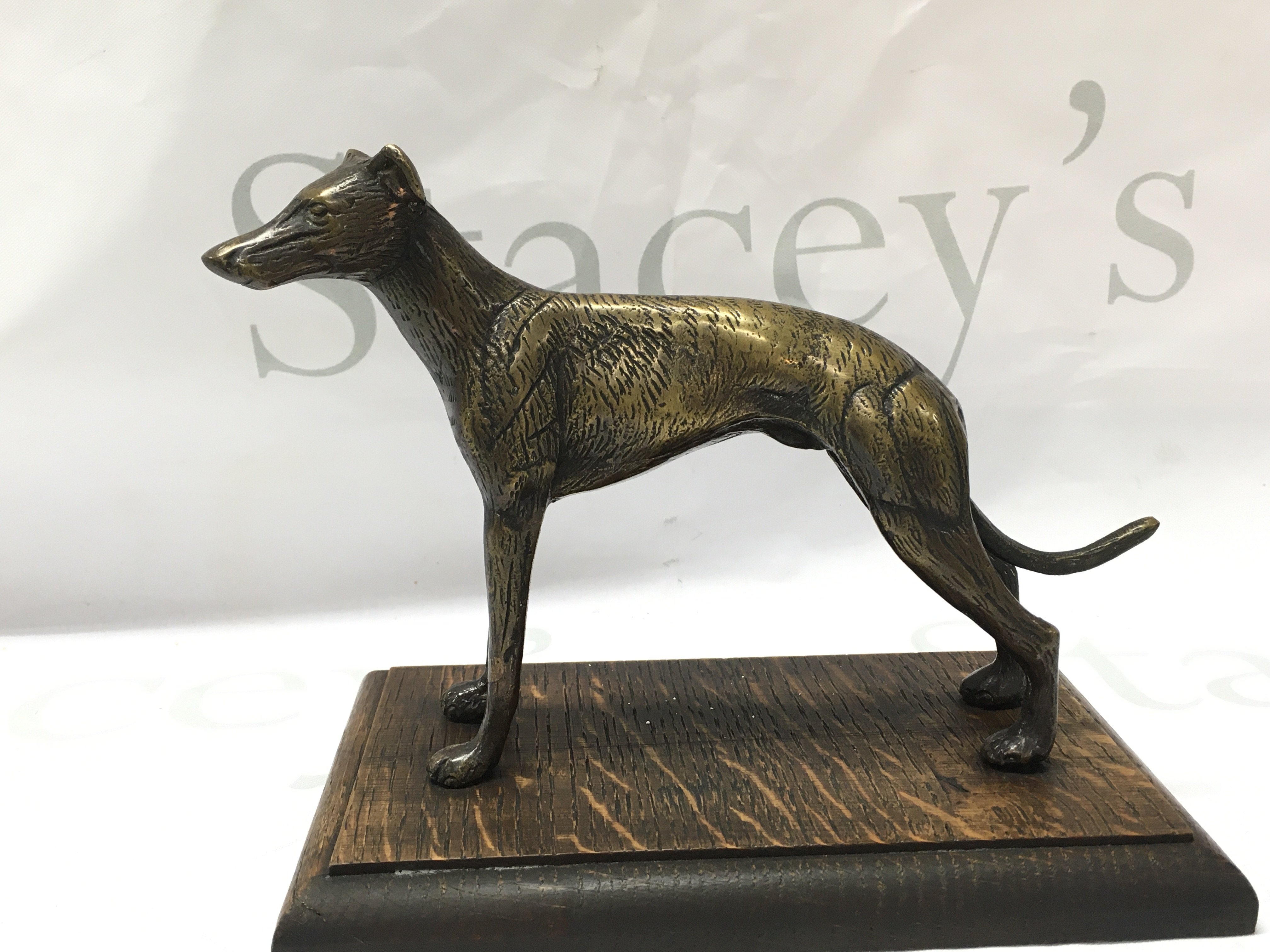 A bronze greyhound on a oak base 15cm tall. Postage category b