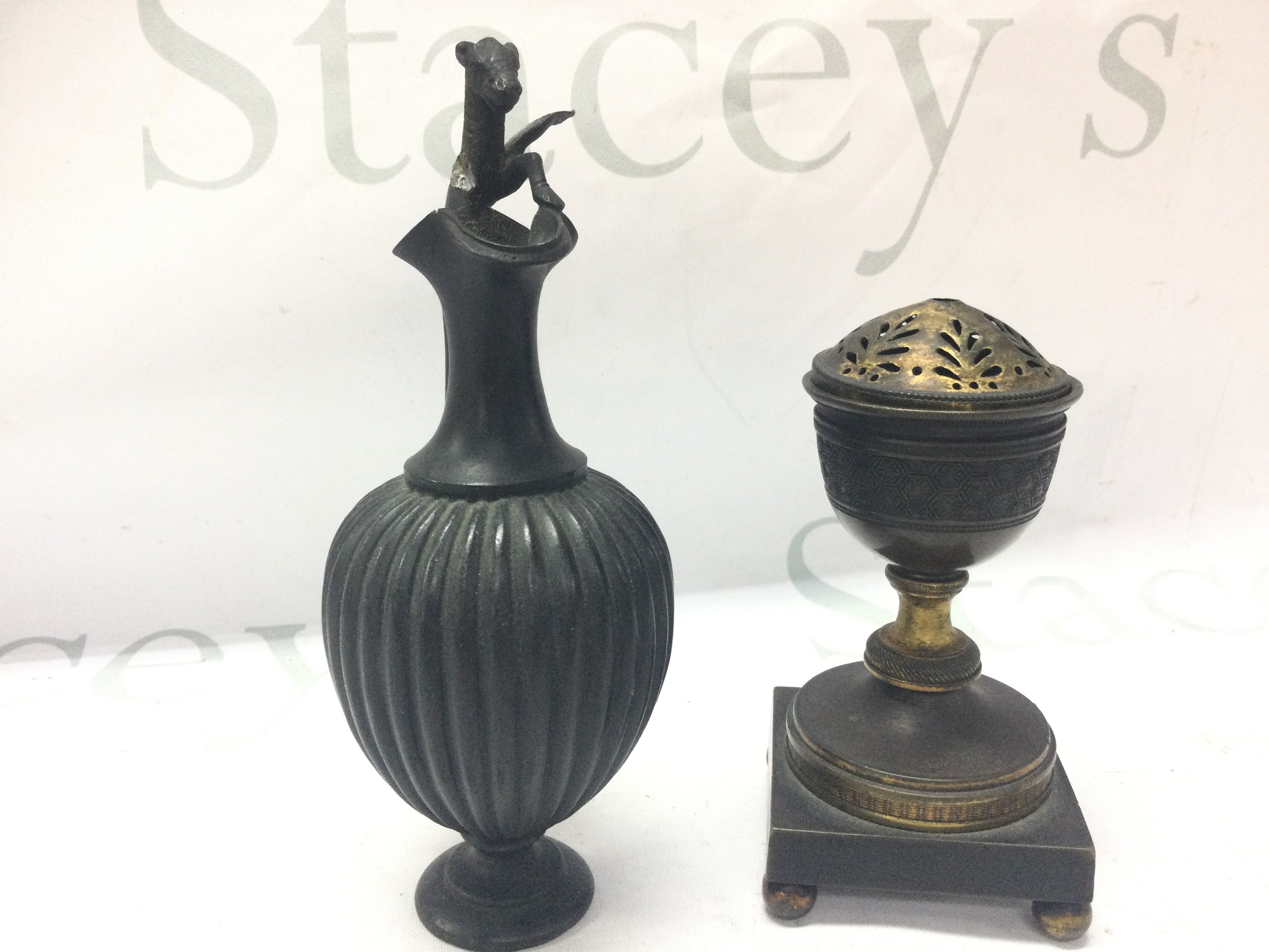 A small bronze ewer and a George III gilt metal pot porri 13 and 17cm tall. Postage category B