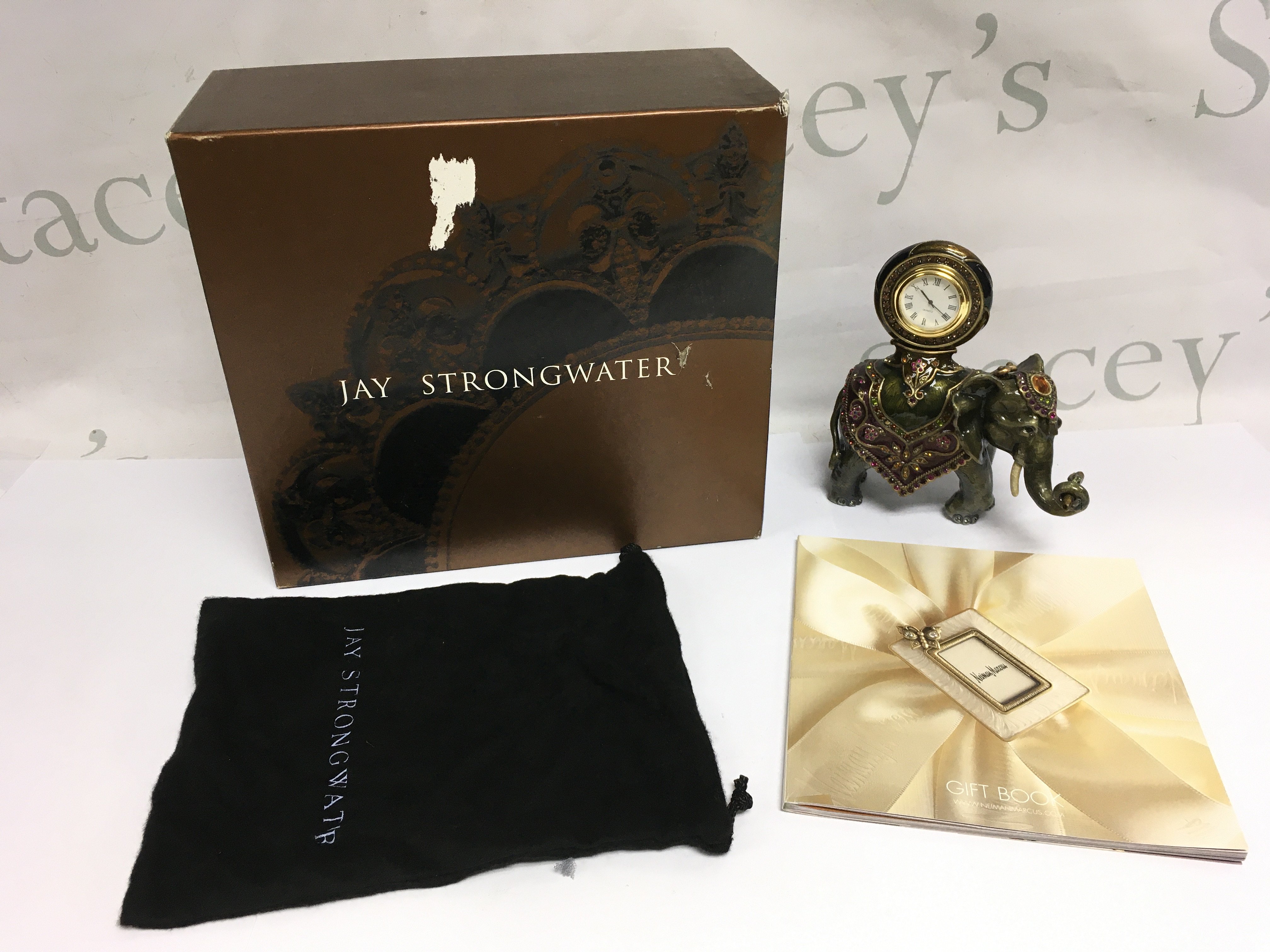 A boxed Jay Strongwater cast metal elephant figural clock decorated with hand set Swarovski crystals, approx height 15cm. Shipping category D.