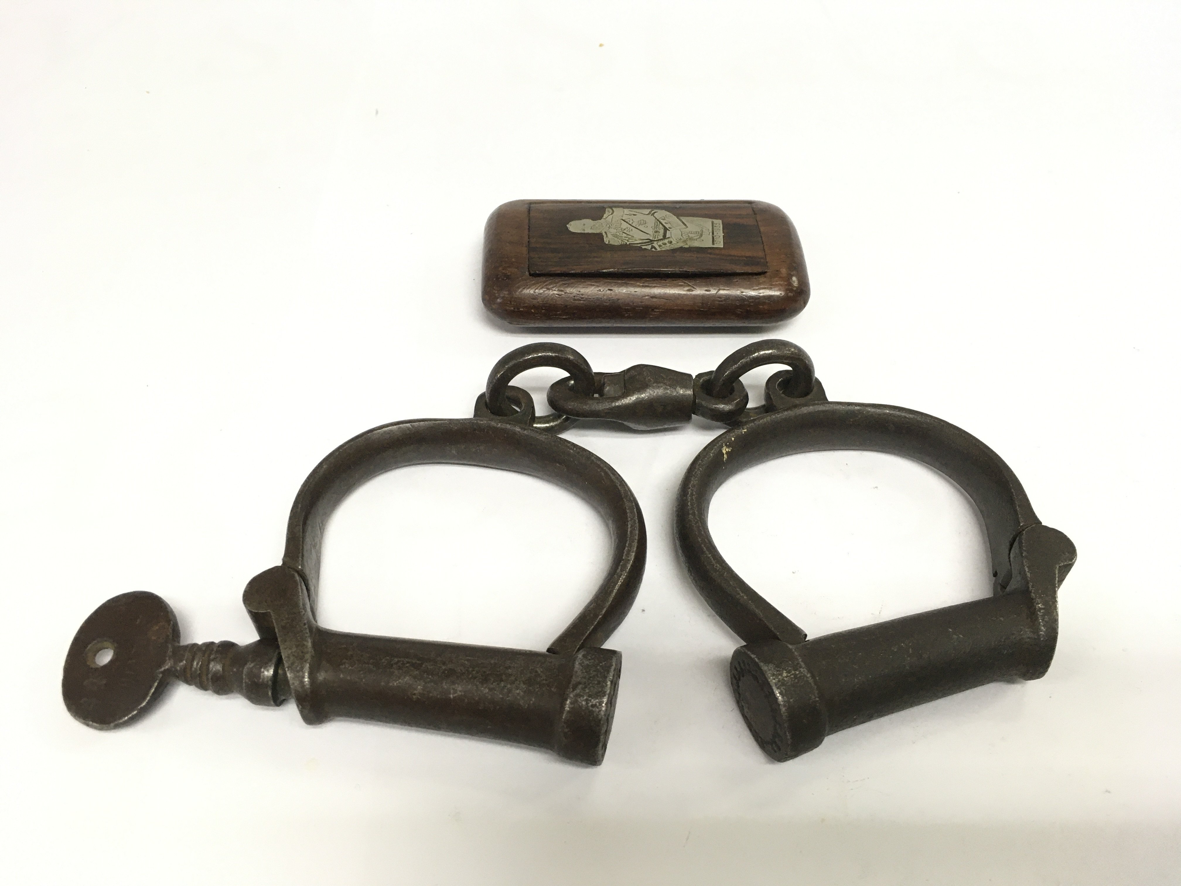 A pair of Victorian handcuffs and an inlaid snuff box (2). Shipping category B.