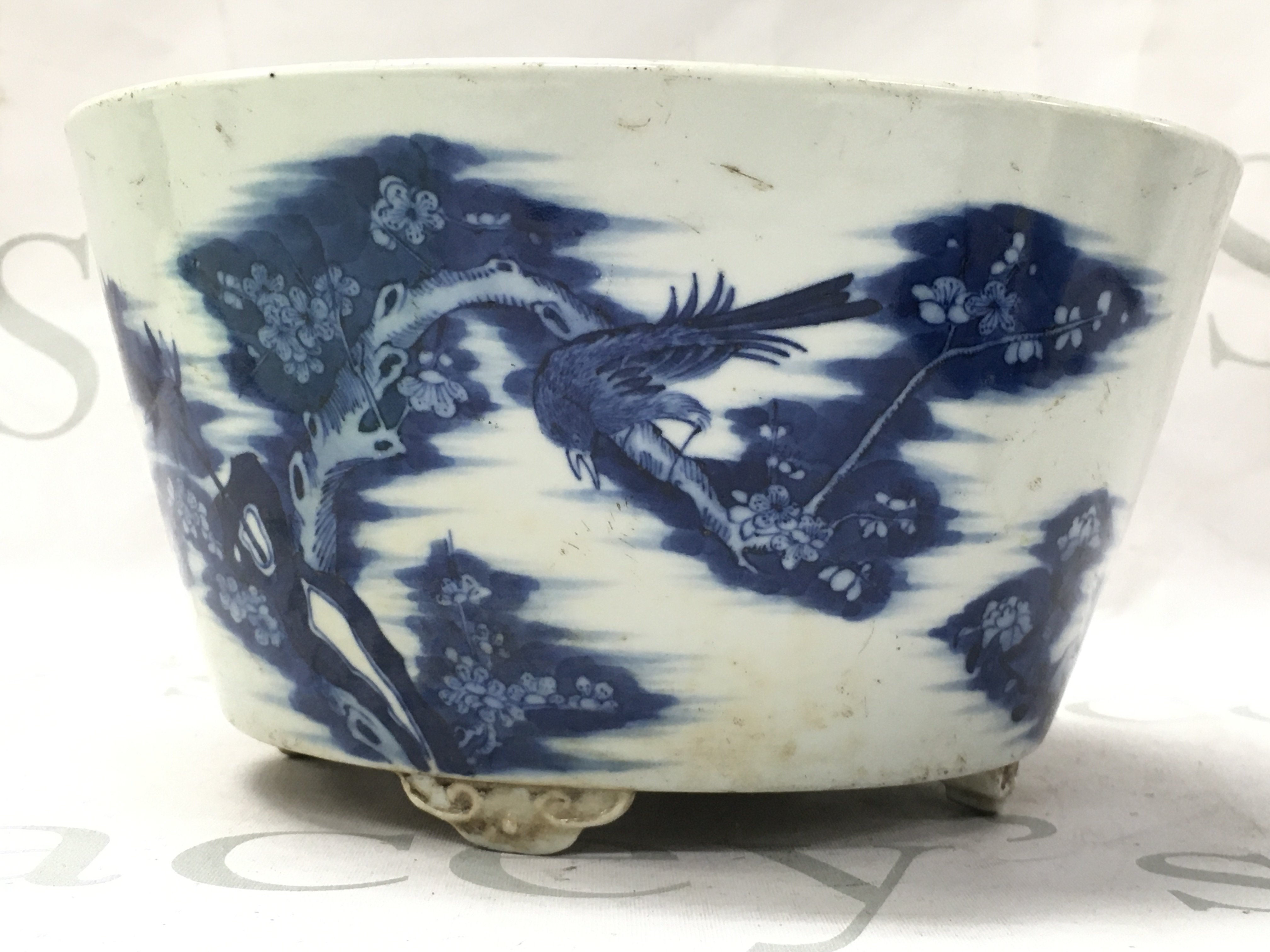 A Chinese blue and white planter bowl decorated with birds perched on cherry blossom trees. 11.5cm tall 21cm wide Approx . This lot cannot be posted