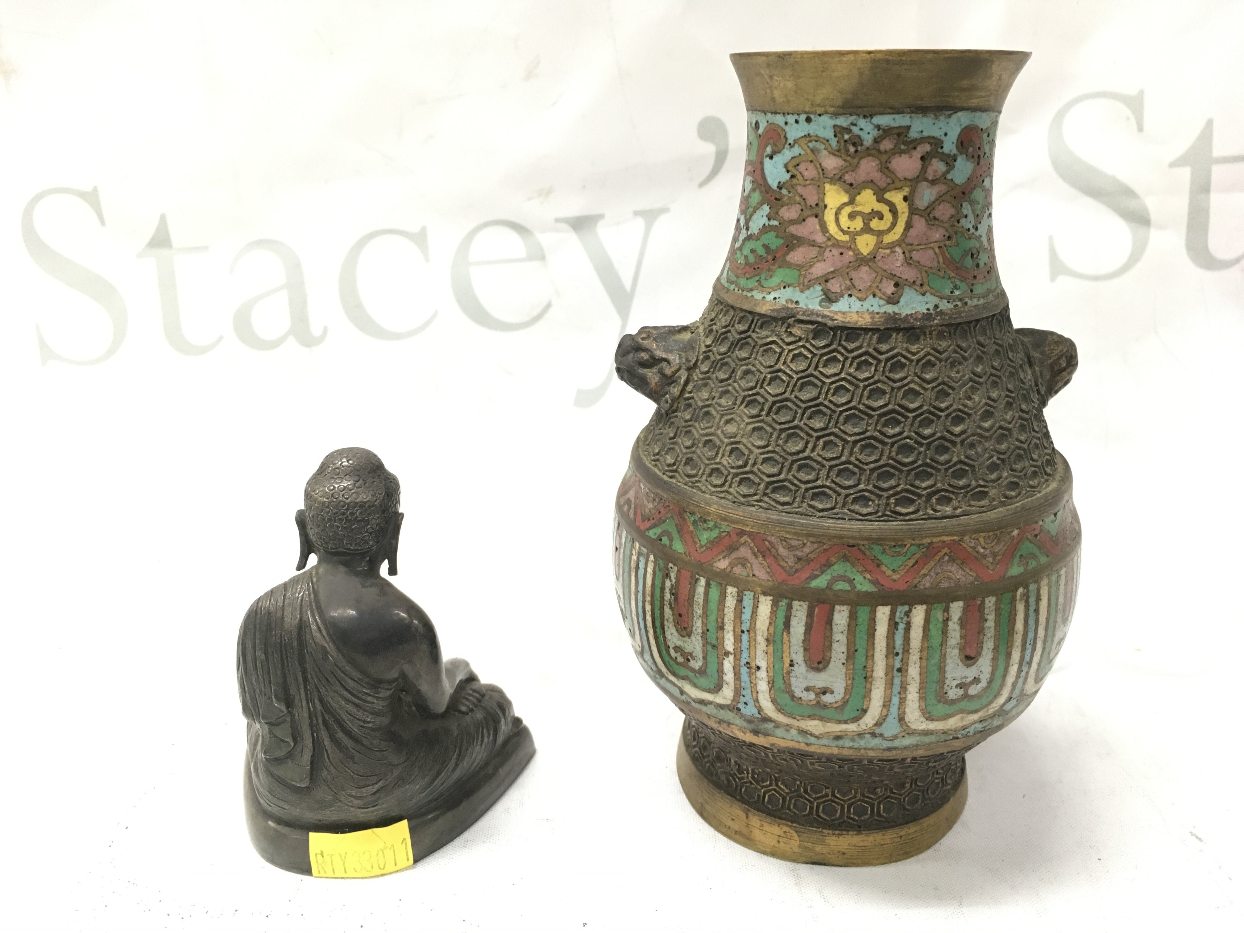 A Japanese bronze enamelled vase (15cm tall) and a seated Buddha figure (8cm tall) . Postage cat b