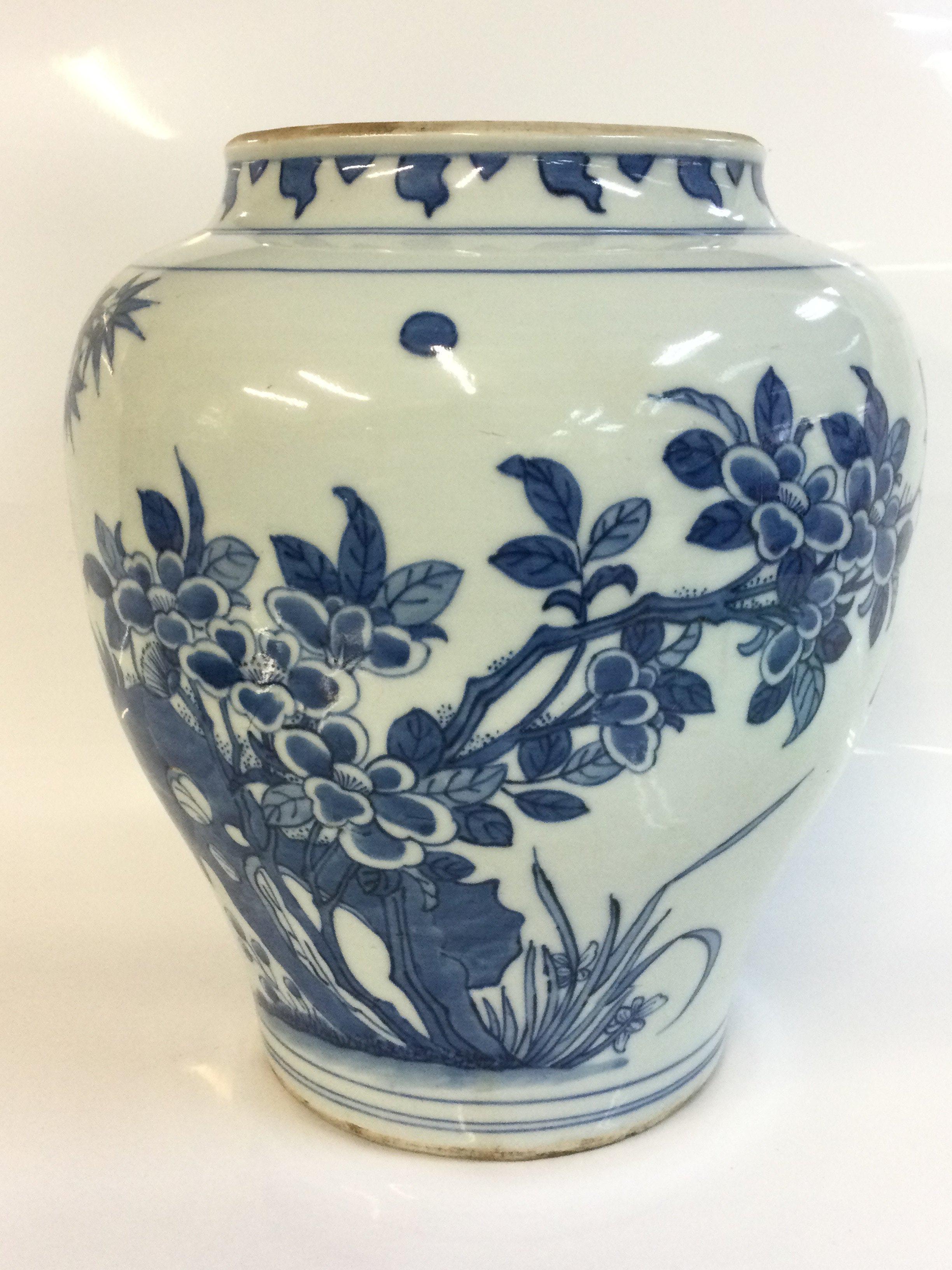 A Chinese blue and white vase with bird and floral decoration. 27cm tall approximately. This lot cannot be posted