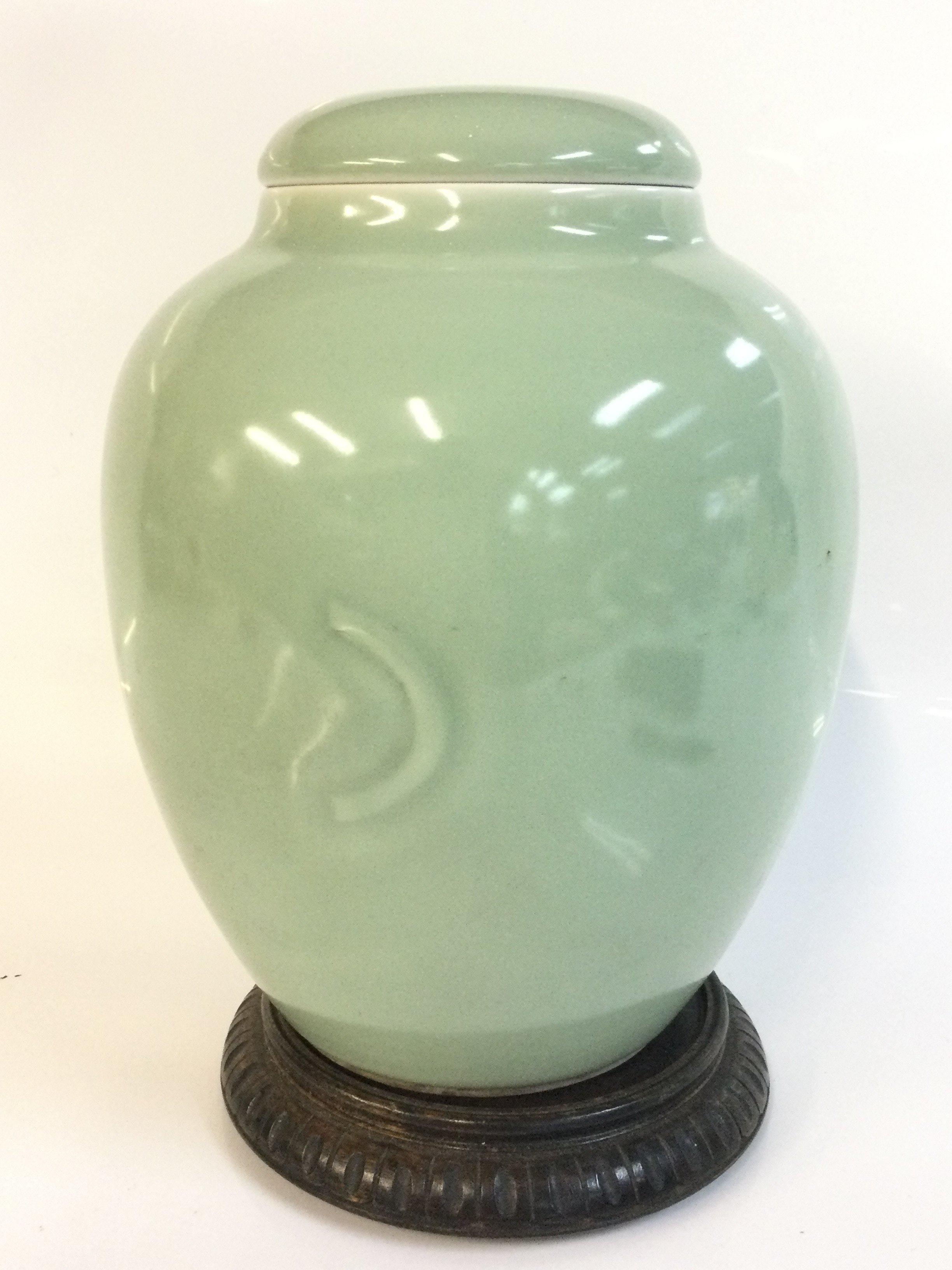 A green vase , 25cm tall . This lot cannot be posted
