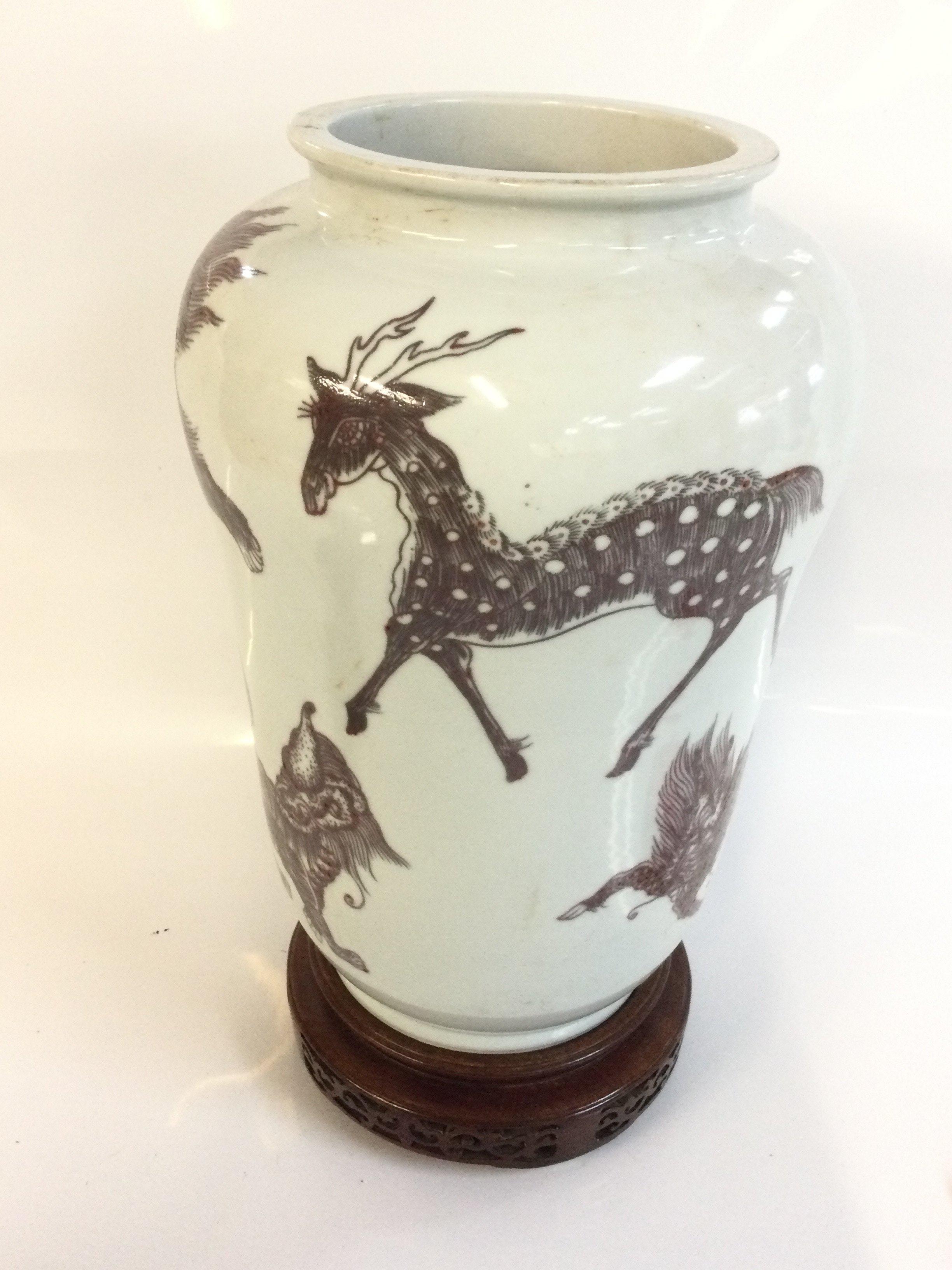 A Chinese iron red vase decorated with mythical creatures. With a six character mark at base. 26cm tall. This lot cannot be posted