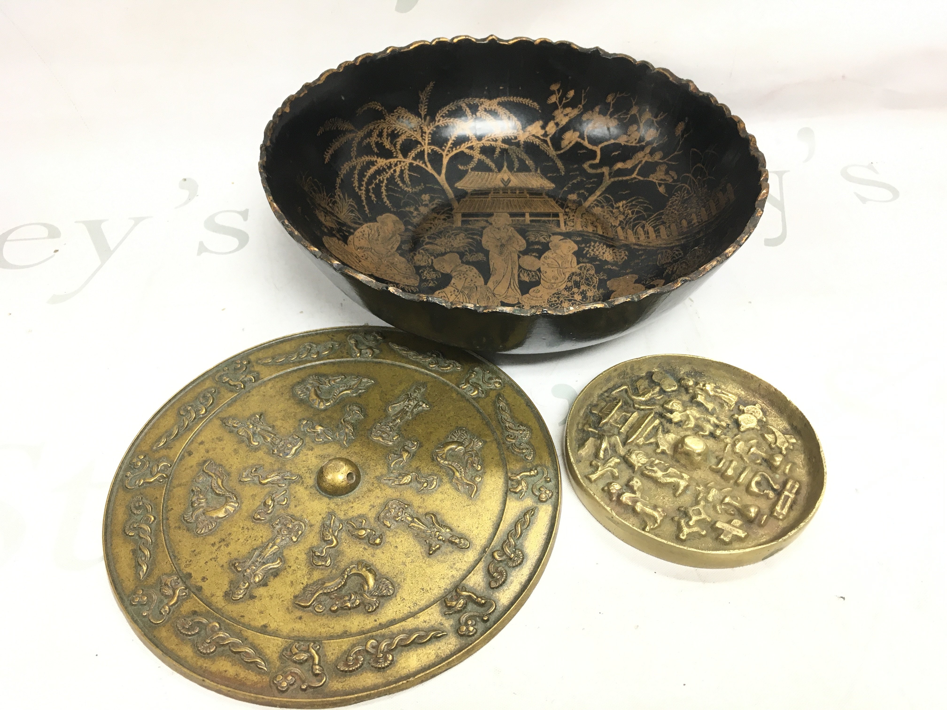 Two Chinese bronze mirrors 17 and 10cm wide and a Japanese bowl 23cm wide. Postage category B