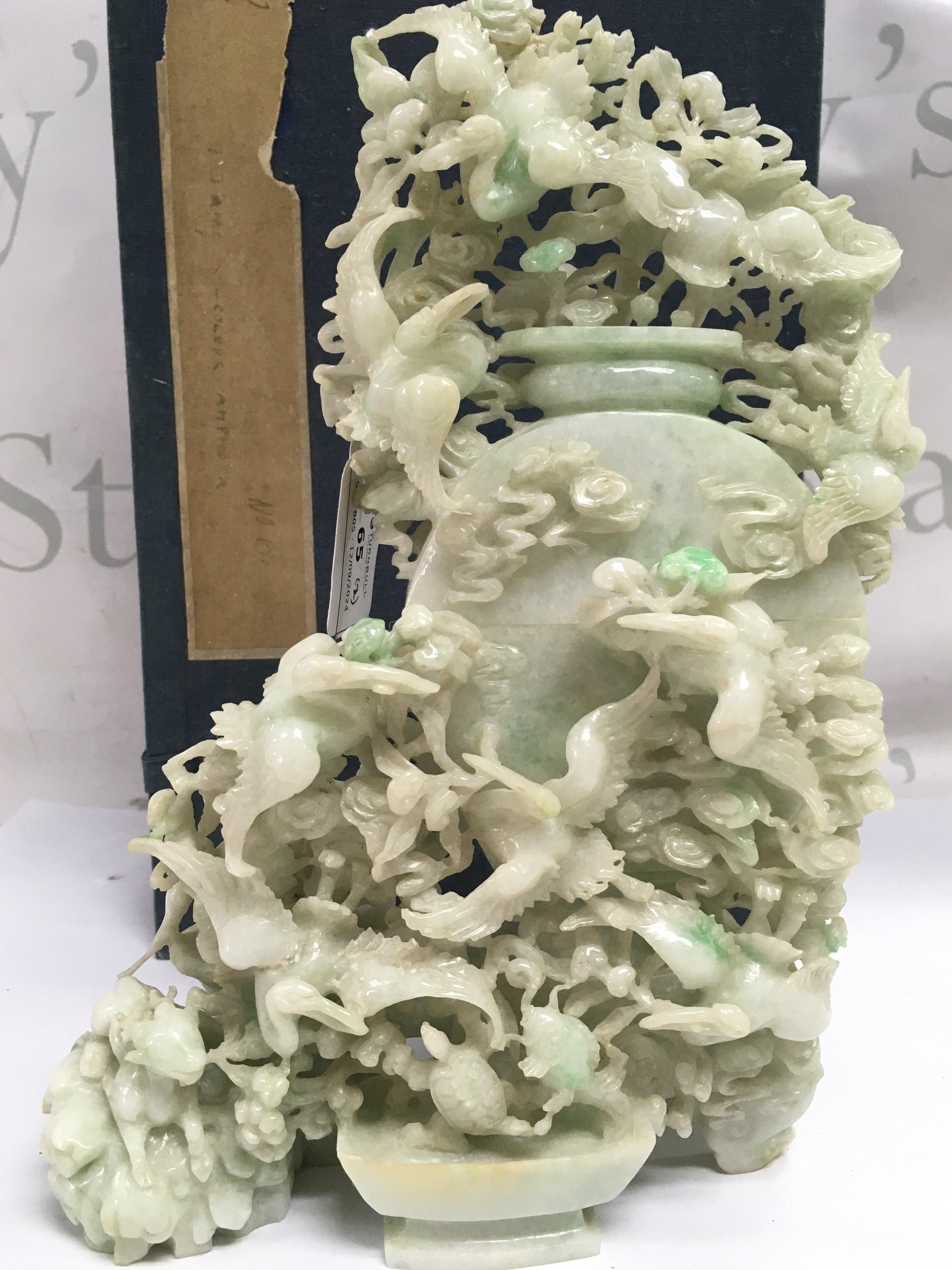 An impressive 20th century Apple Green dye Jade lidded pot surrounded by cranes and other animals, with box. Approximately 25cm tall 16cm wide . This lot cannot be posted