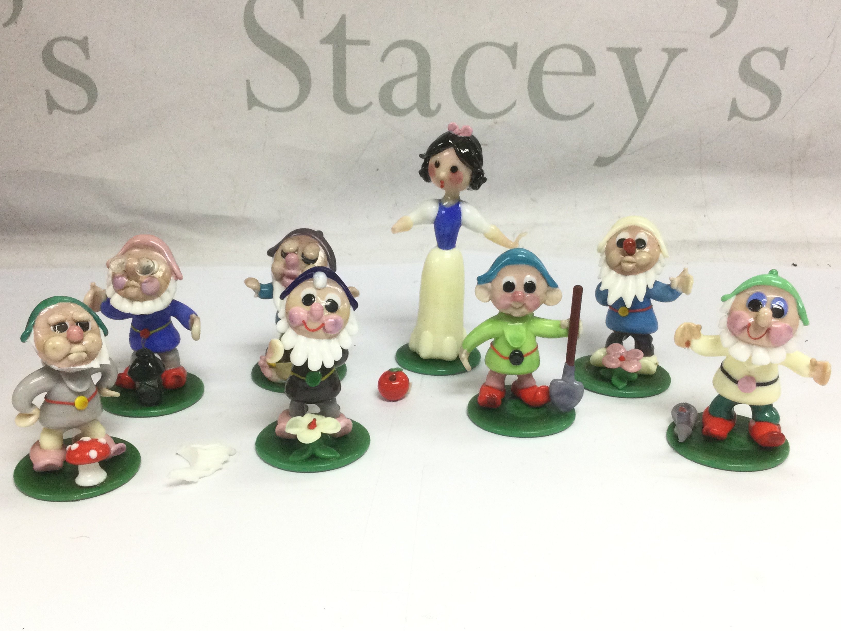 A set of glass Snow White and the Seven dwarves figures. Shipping category D.