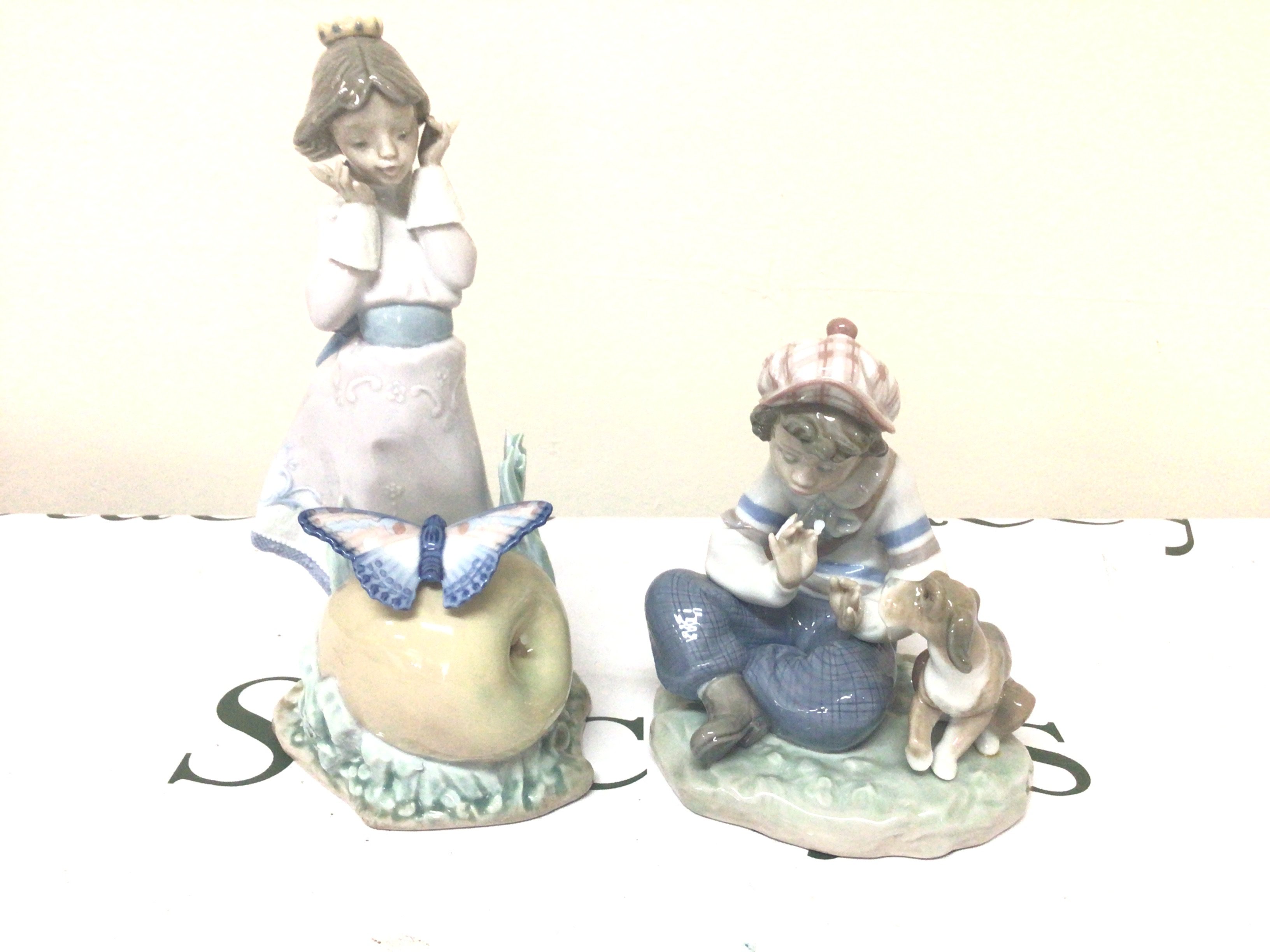 Two Lladro figures a boy seated with his dog and young girl with a butterfly (2)