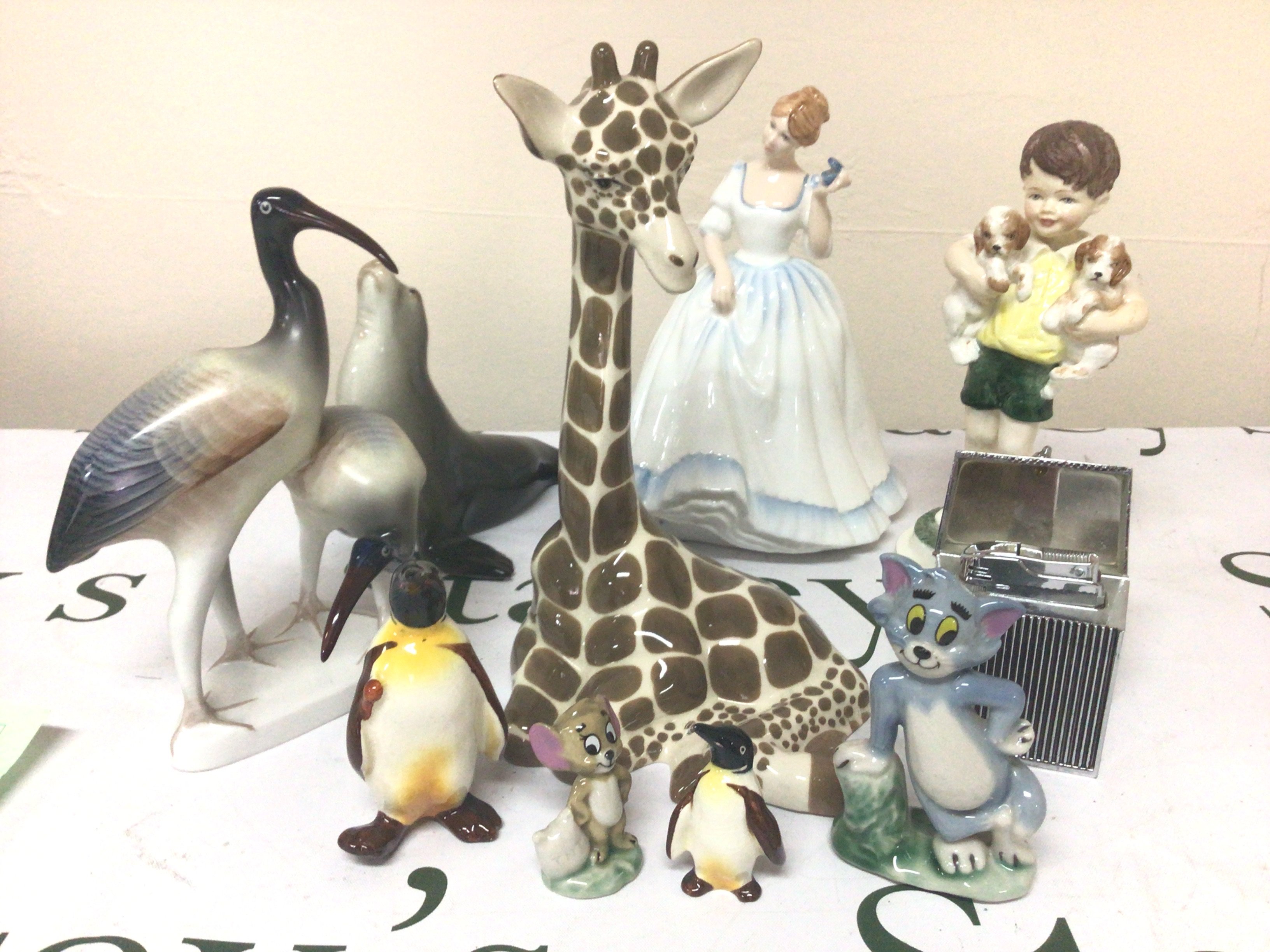 A collection of Worcester Doulton Wade and other ceramic figures a lighter in the form of a Rolls Royce Car grill. and other oddments.