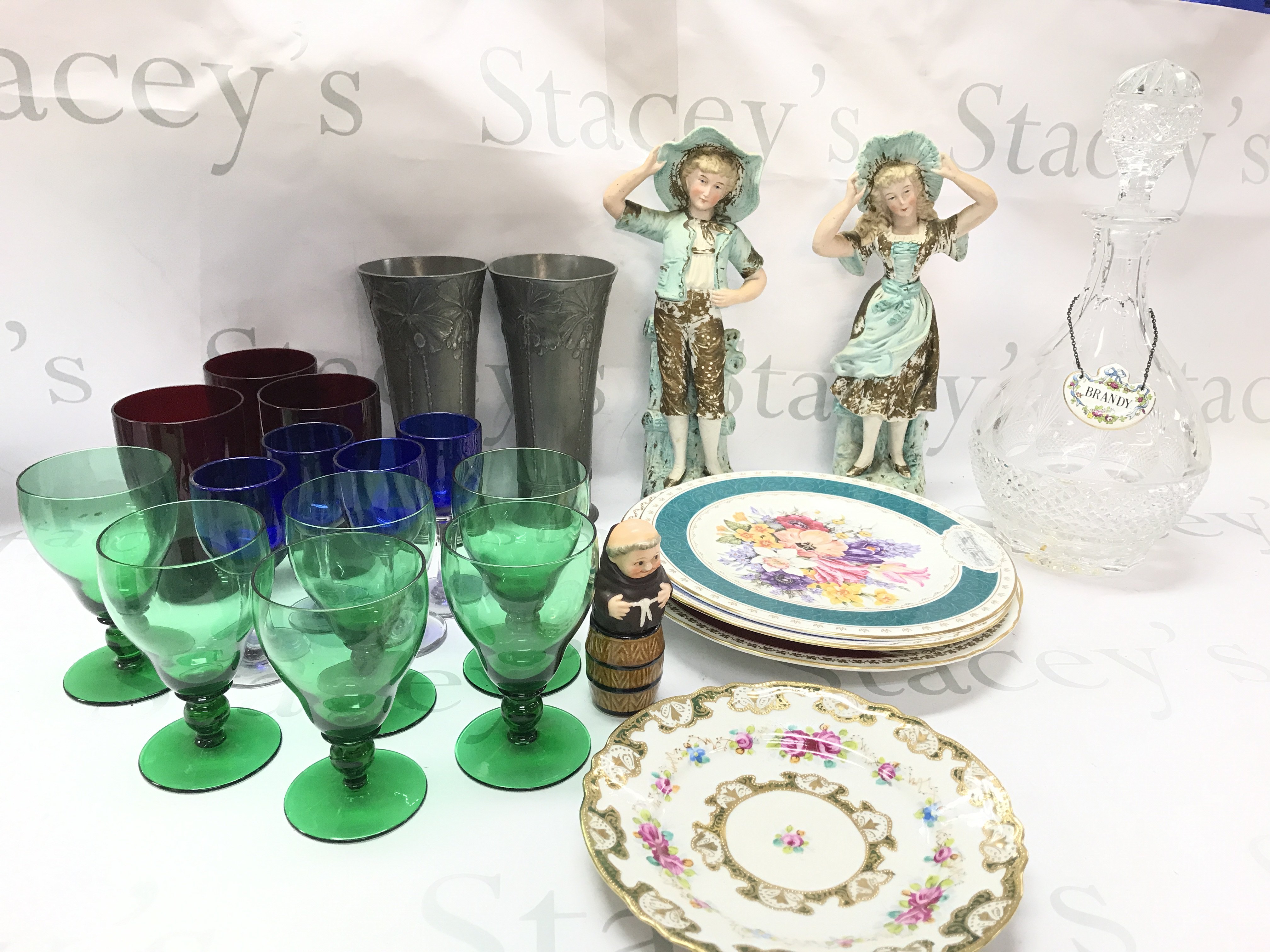 A collection of coloured glass including red, blue and Green cups, late 19th century pewter German pair of vases , Royal Horticultural Chelsea flower show porcelain plates, cut glass brandy decanter, Royal Worcester Queen figure. This lot cannot be posted