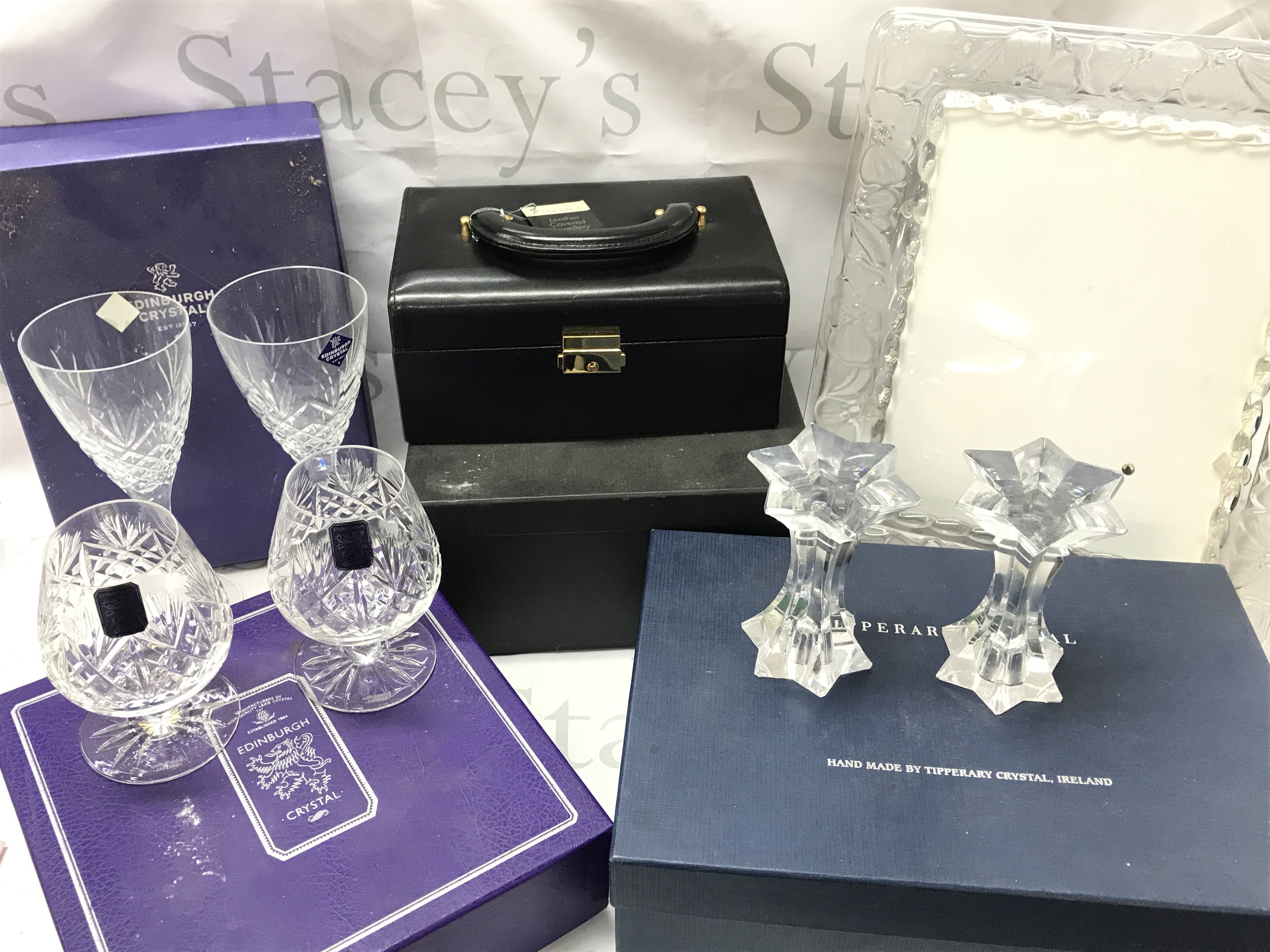 Boxed crystal class including Edinburgh crystal glasses, Tipperary crystal candlesticks, boxed as new leather covered jewellery box, marouisby Waterford glass photo frame . This lot cannot be posted