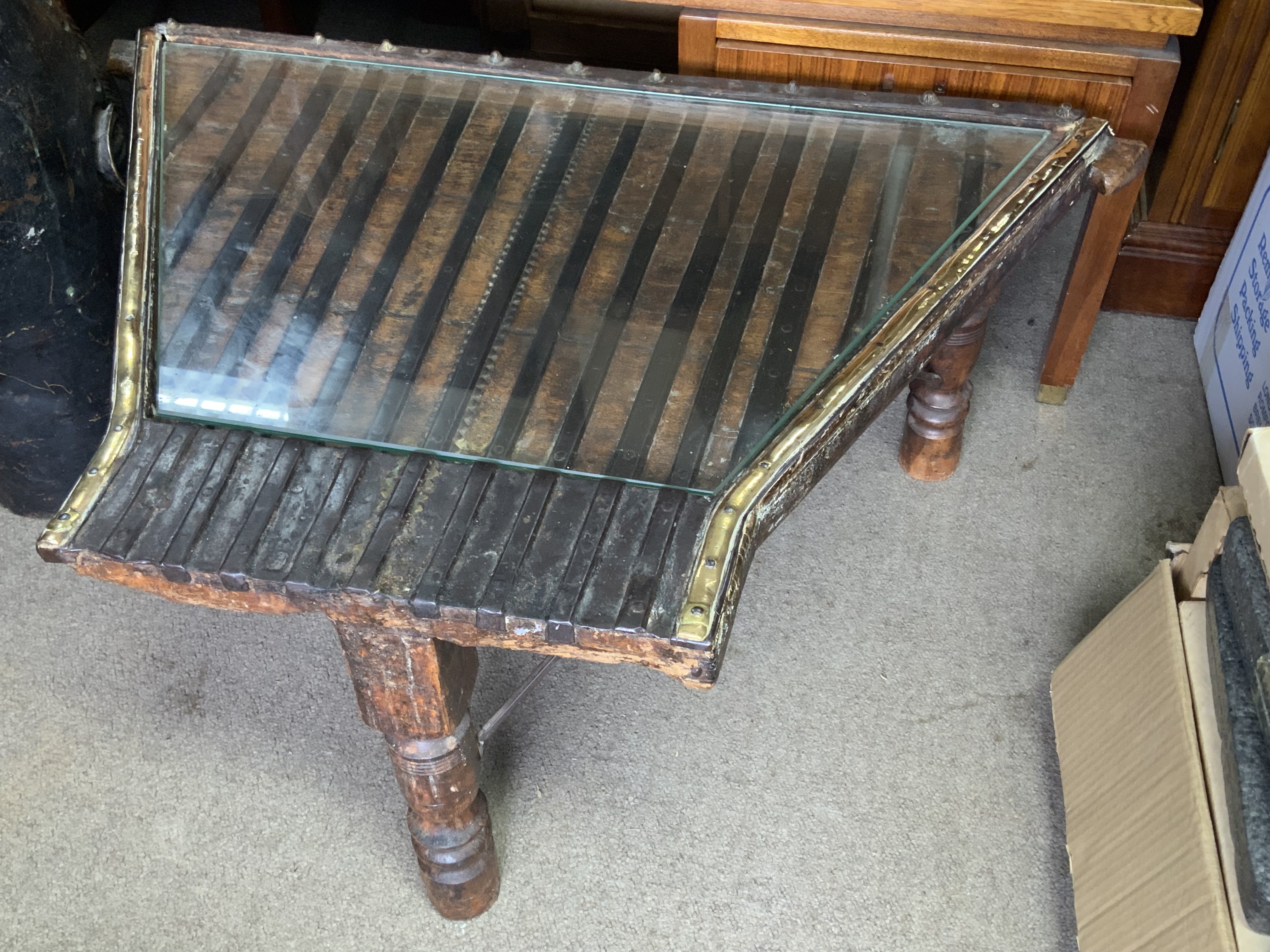 An Indonesian metal bound hardwood stand. 59cm x 94cm x 38cm.