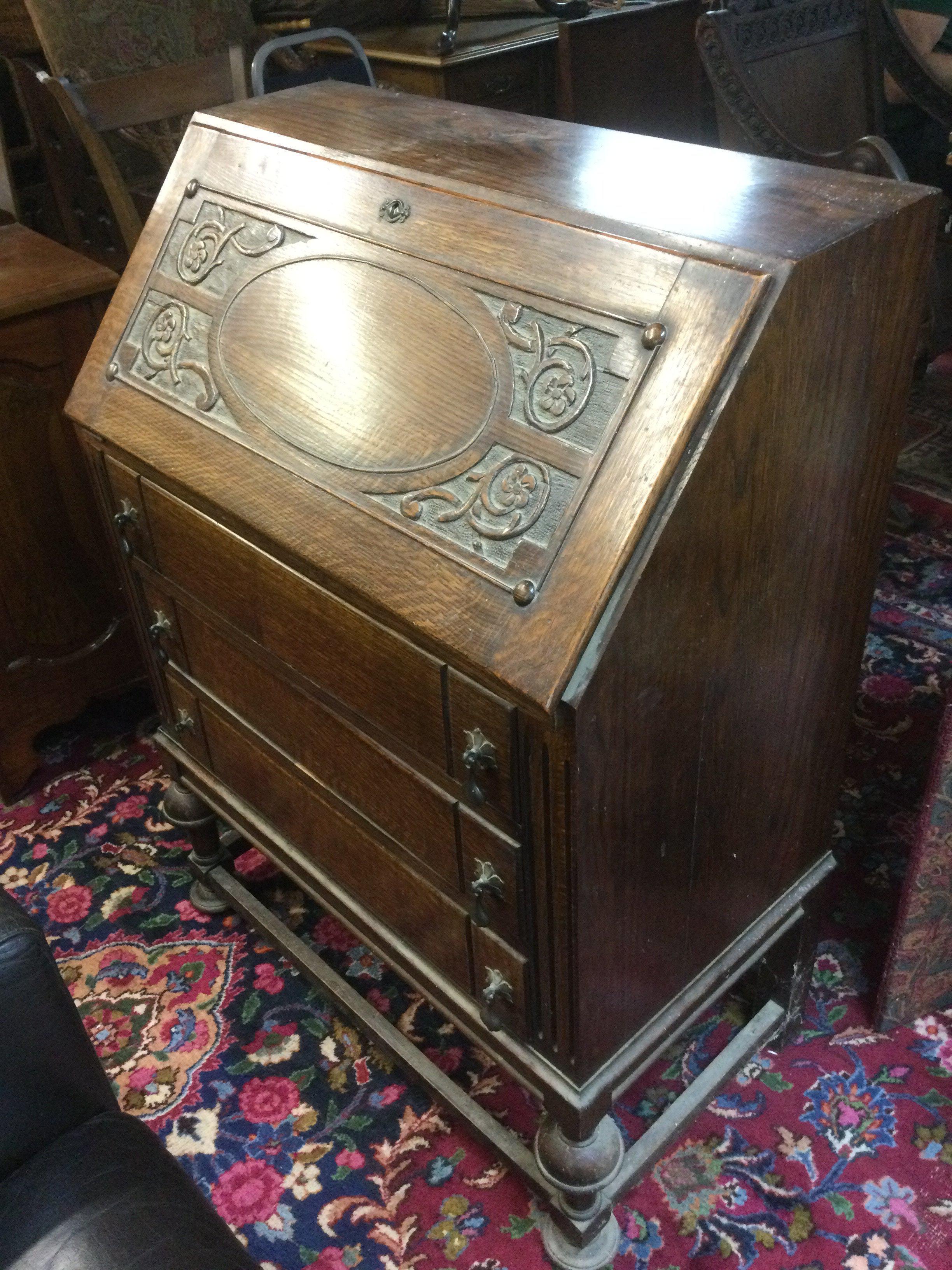 An oak bureau with decorative front panel, approx 73cm x 102cm x 42cm. Shipping category D.