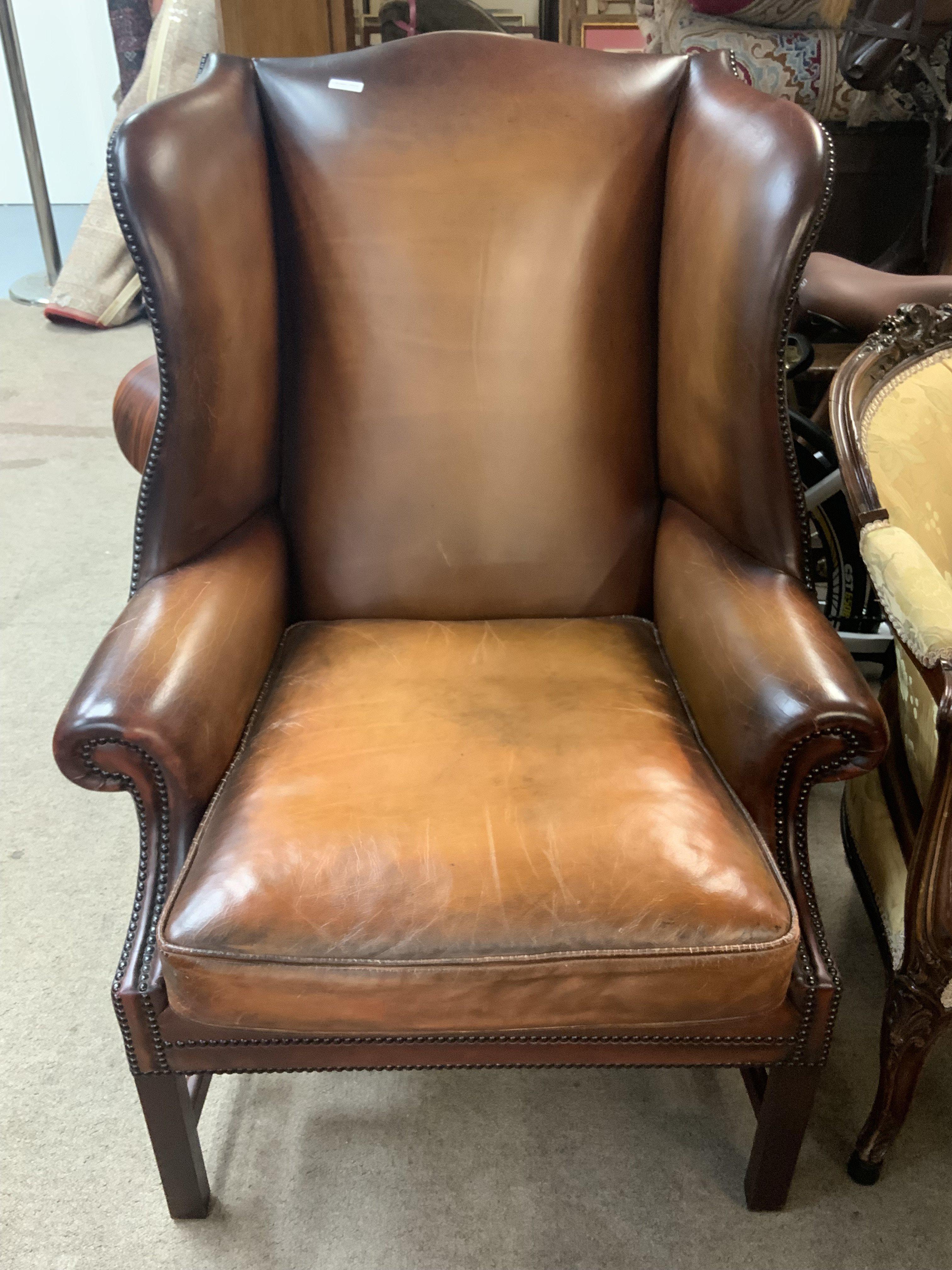 A vintage leather wing back armchair.