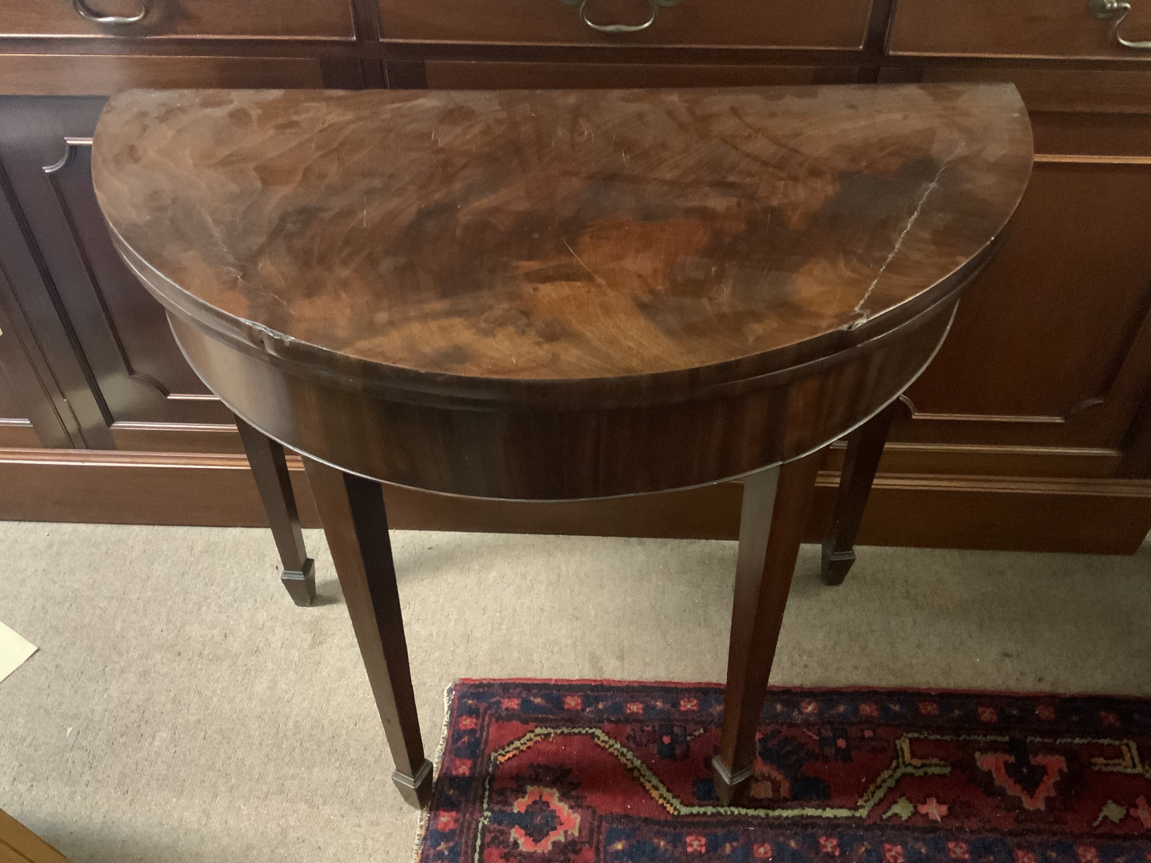 A George III mahogany demi-lune card table.