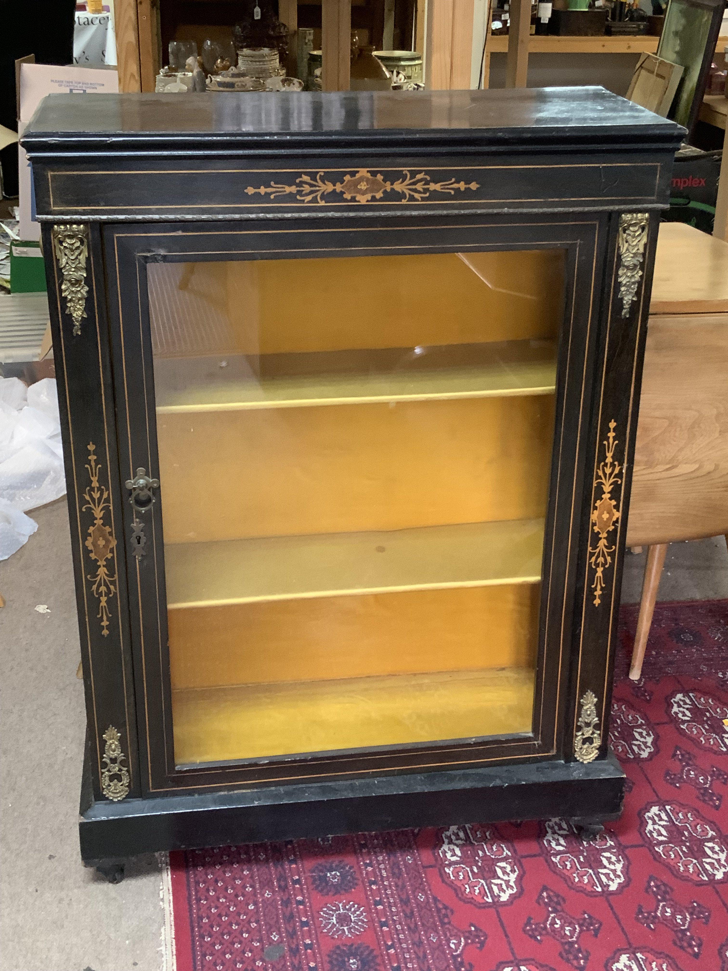 An Edwardian ebonized and inlaid pier cabinet with gilt metal mounts.75cm x 102cm x 31cm