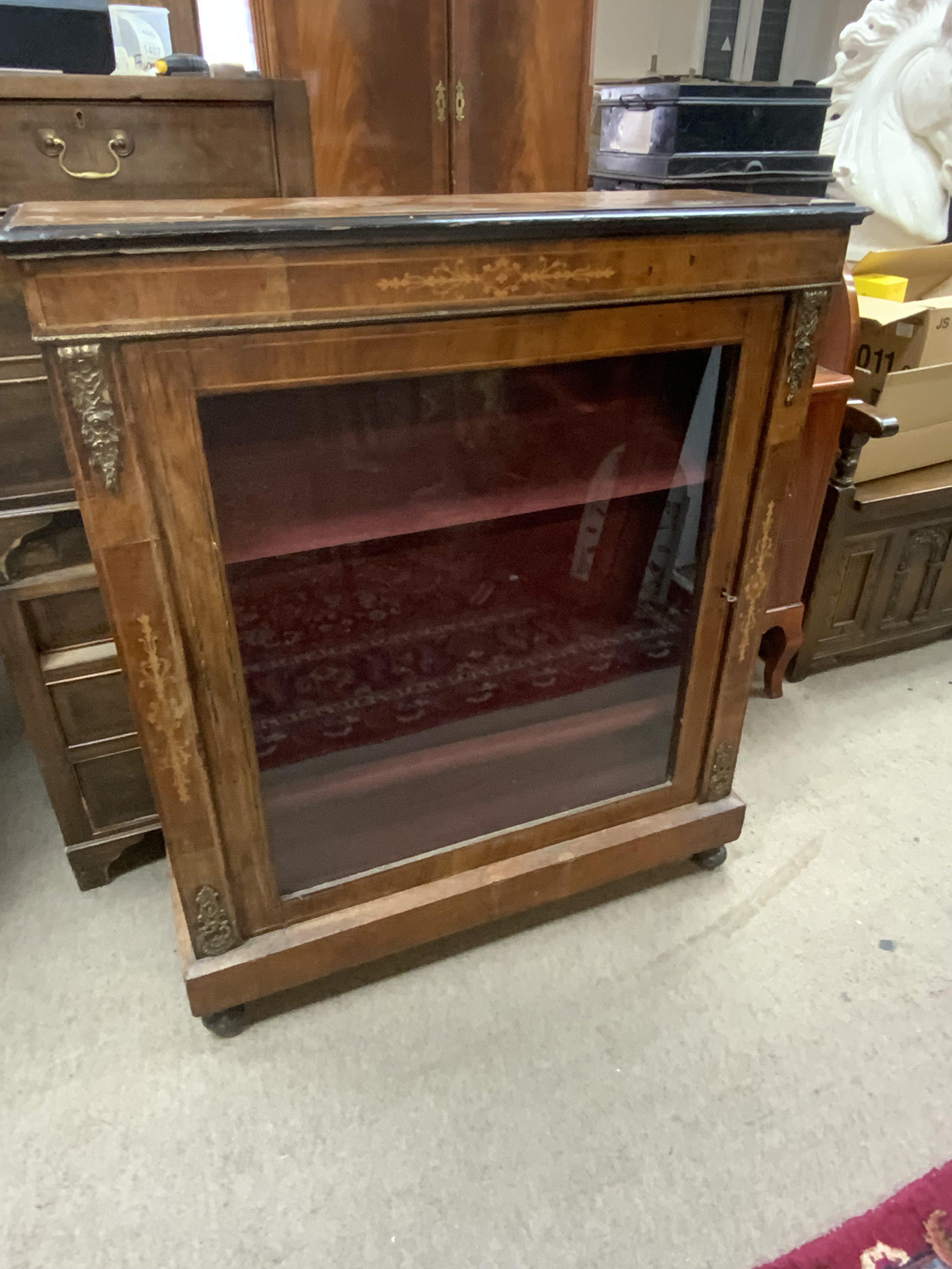 An Edwardian pier cabinet with glazed door, gilt metal mounts and inlay. 91cm x 106cm x 31.5cm