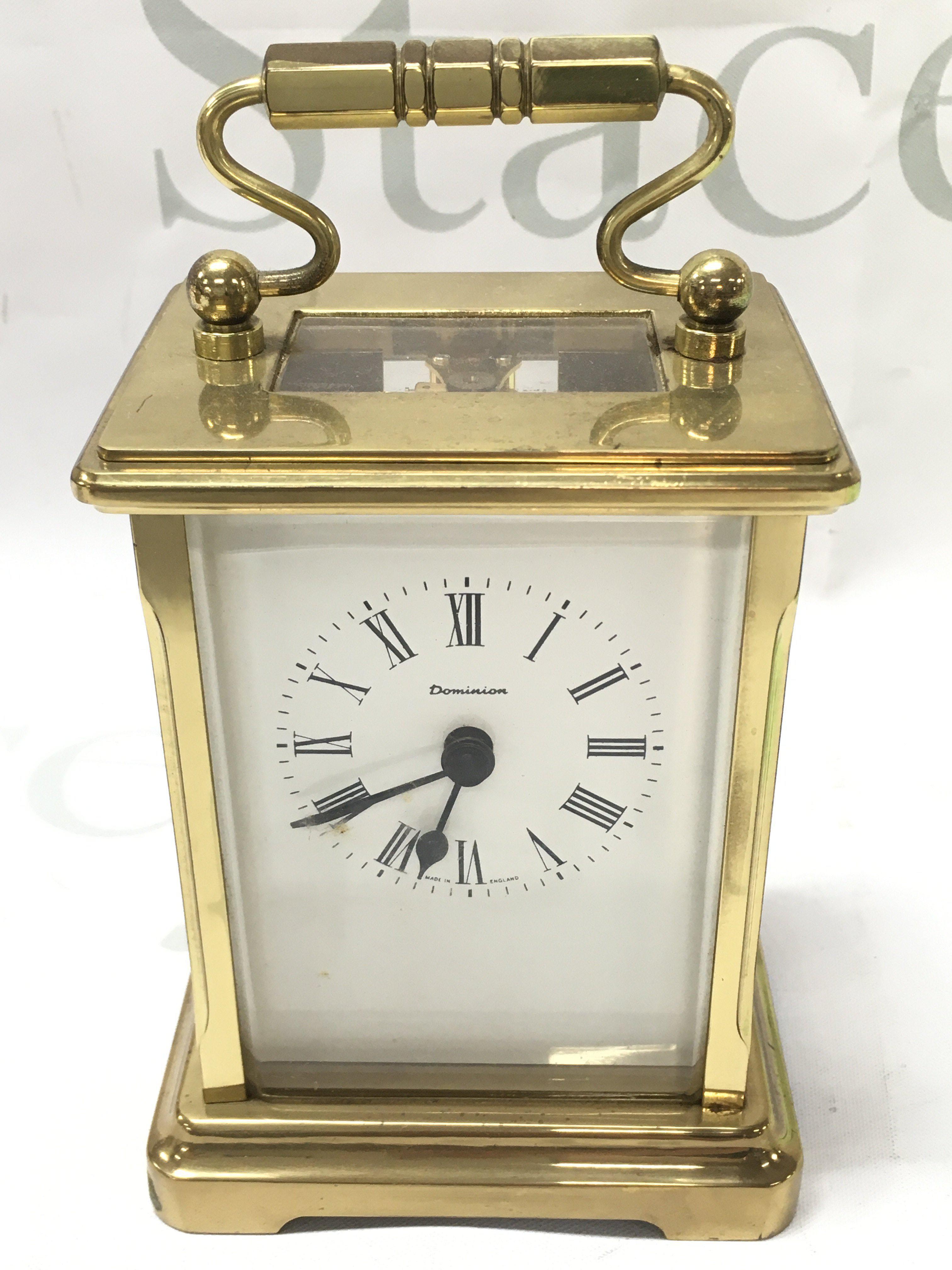 Dominion Carriage clock with key, seen working . This lot cannot be posted