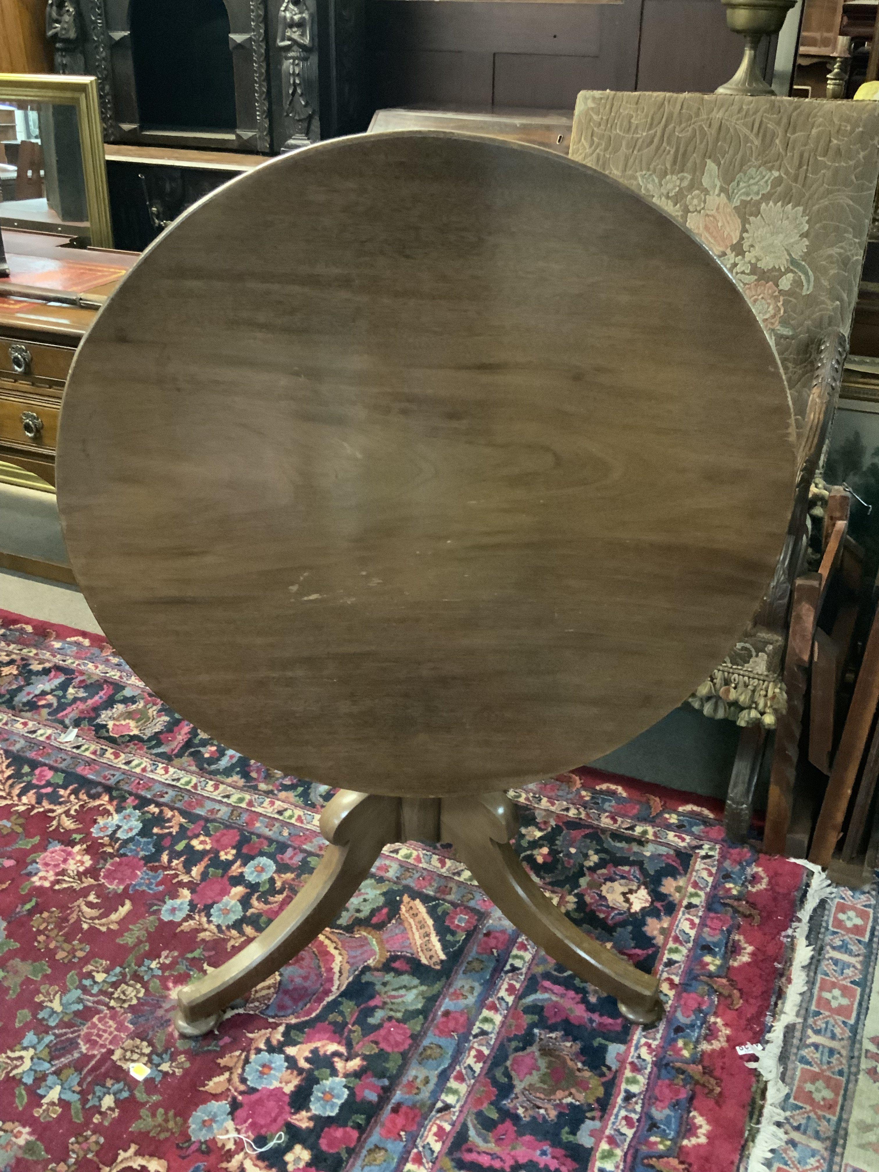 A Circular topped pedestal table, tripod base.