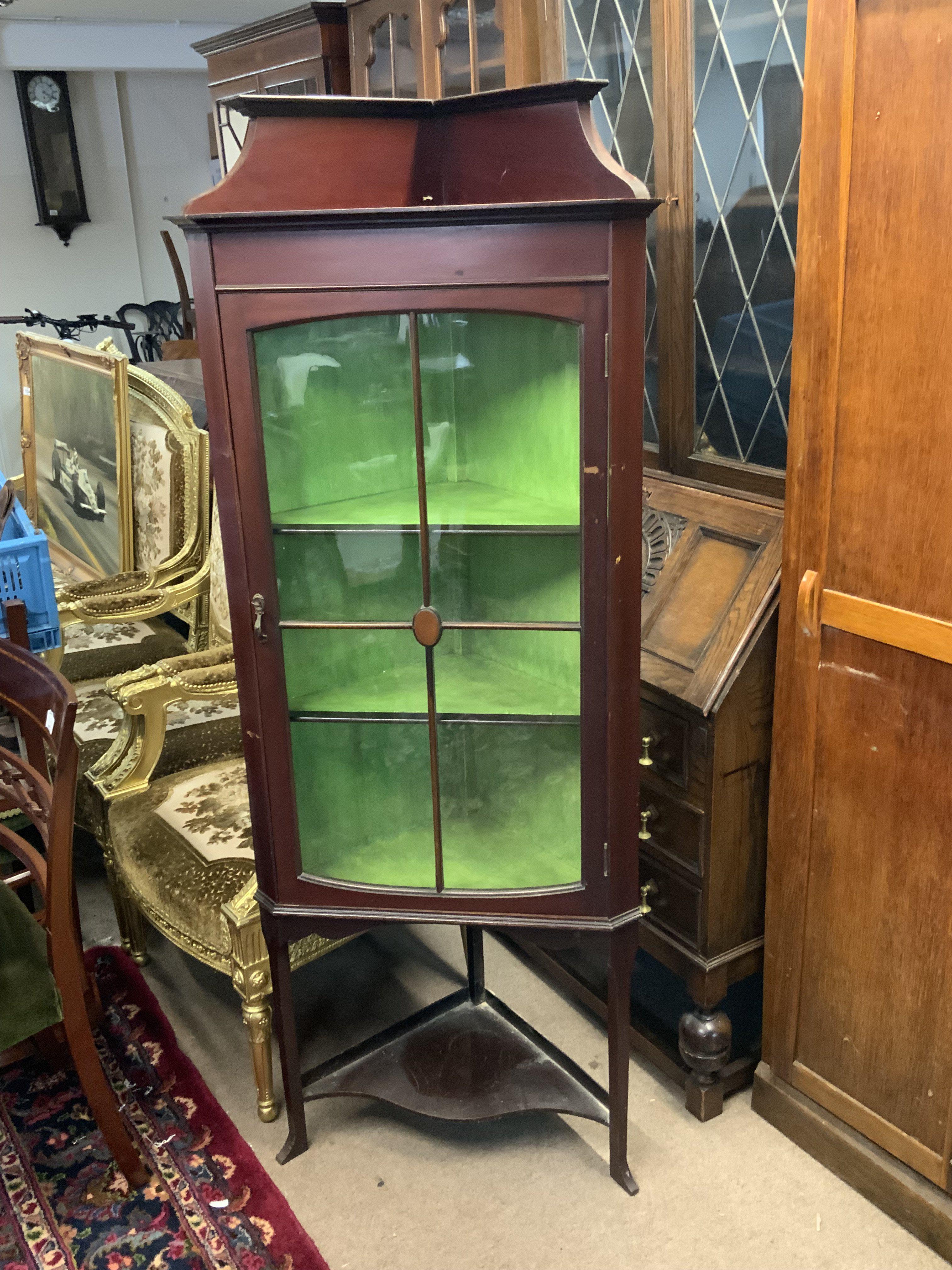 An Edwardian corner display cabinet.