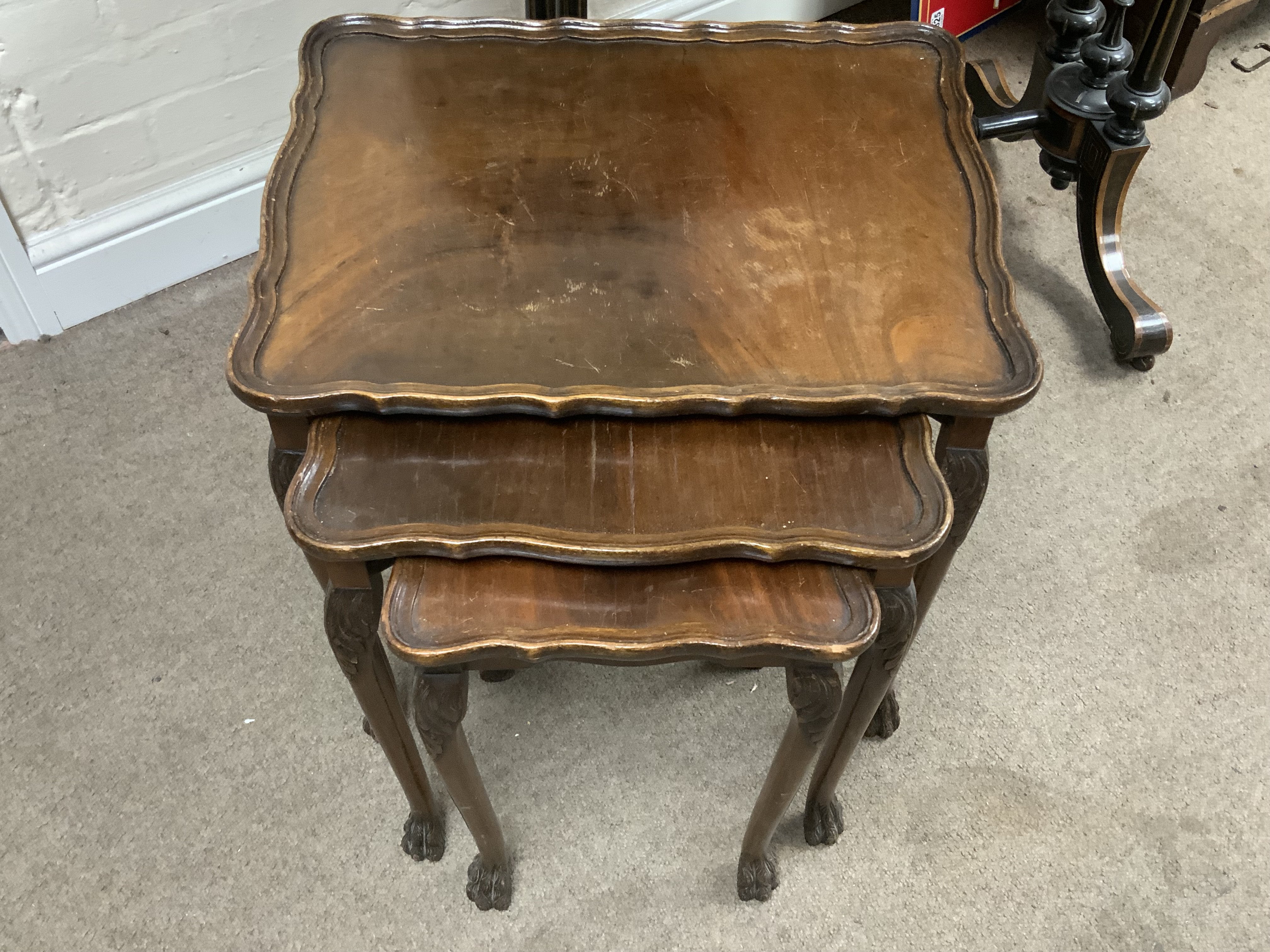 A walnut nest of three tables.