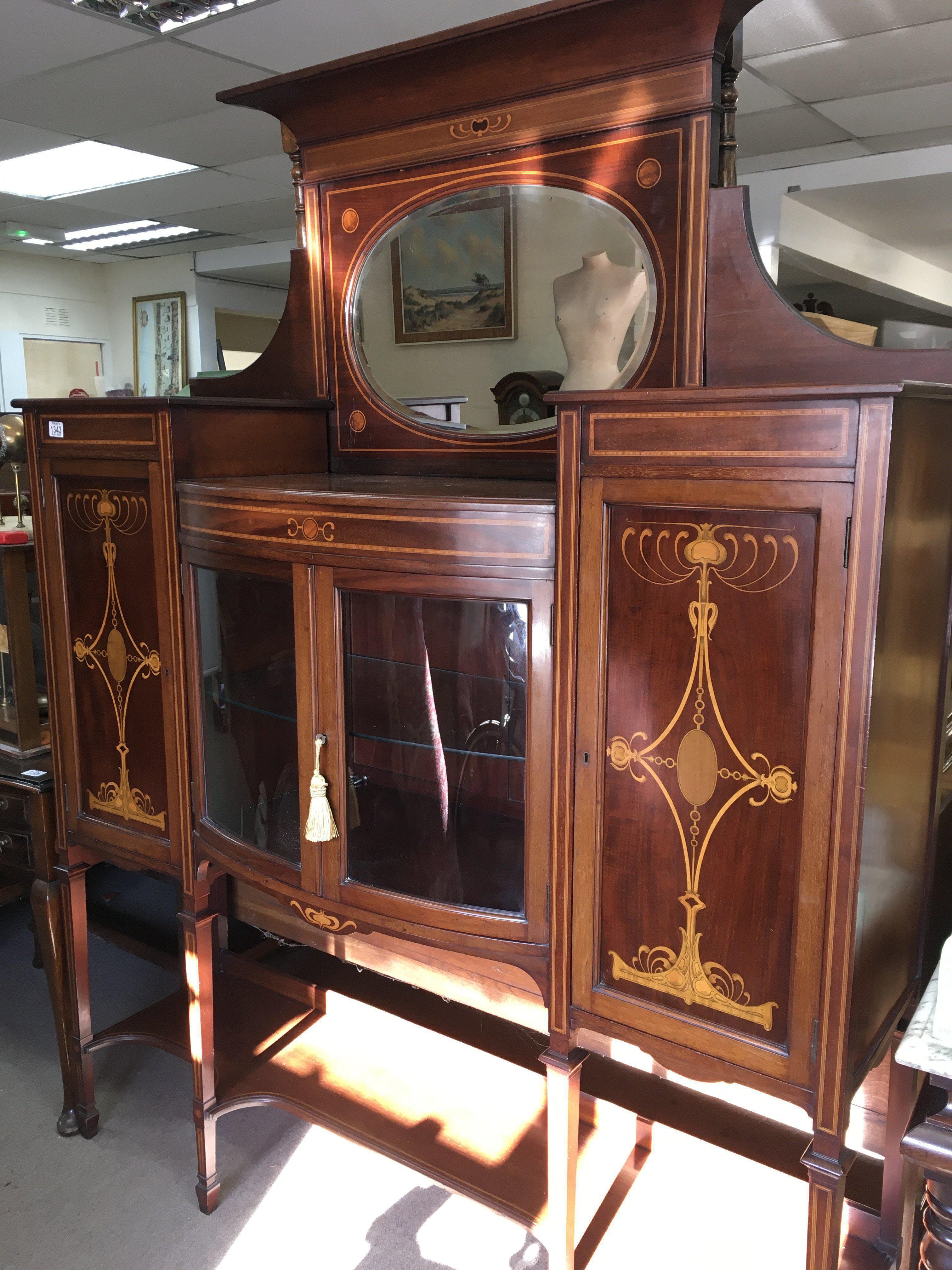 A Edwardian inlaid mahogany display cabinet the rasied mirror back above a pair of glazzed doors flanked by cupboards on square tappering legs . 150 cm x 200 cm . NO RESERVE