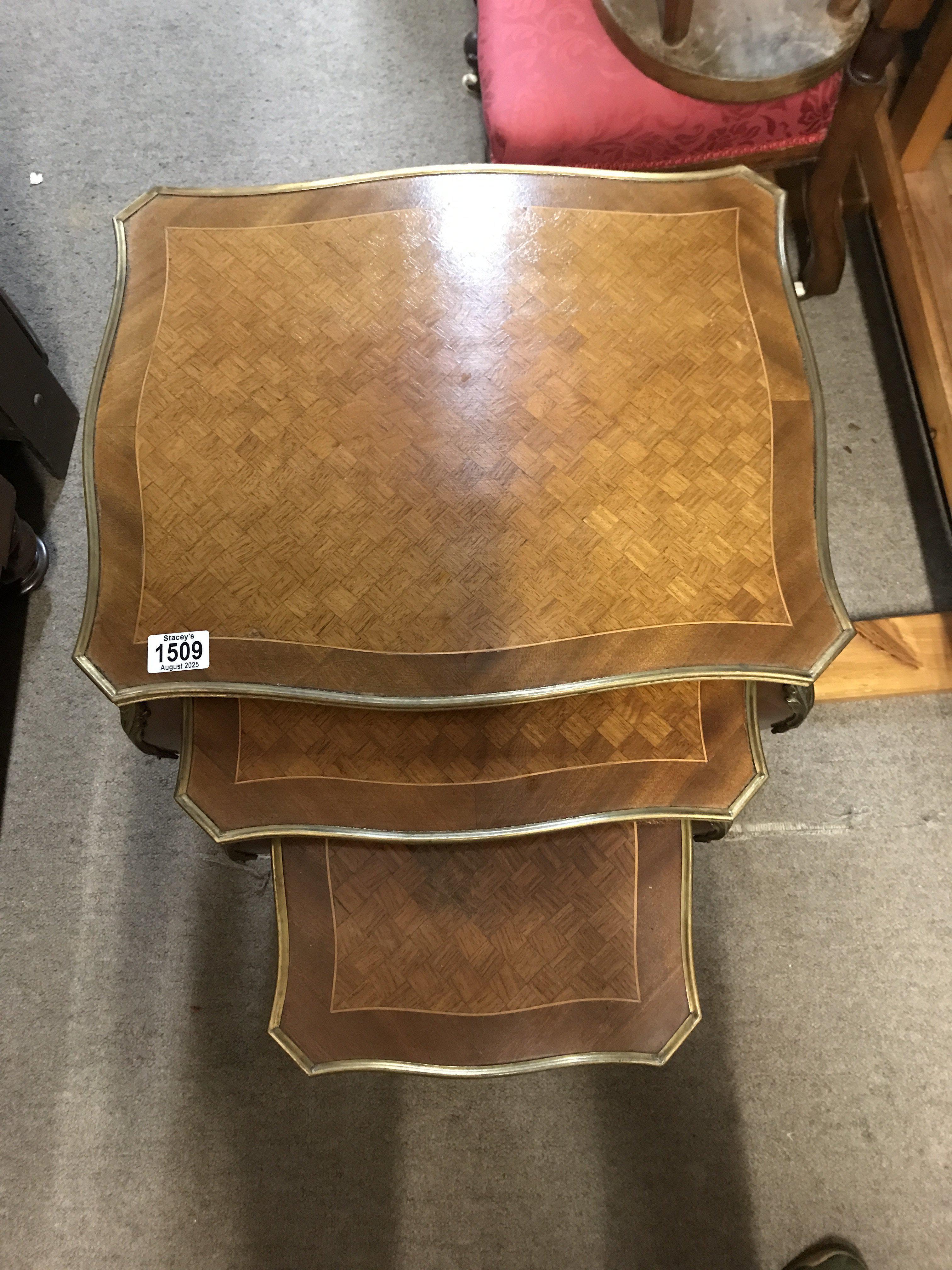 A French gilt mounted marquetry nest of 3 tables. No reserve.