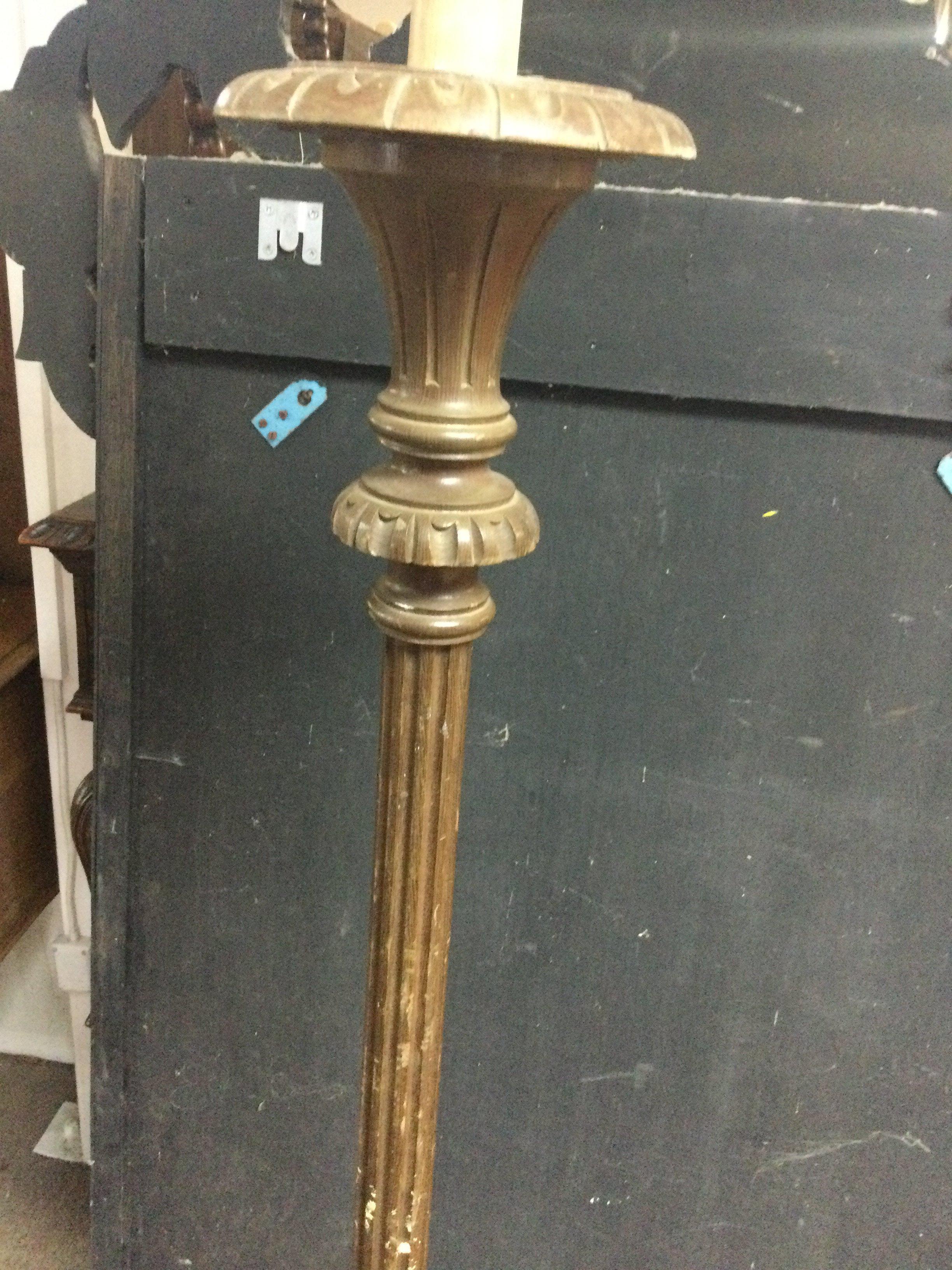 A standard lamp with fluted column .