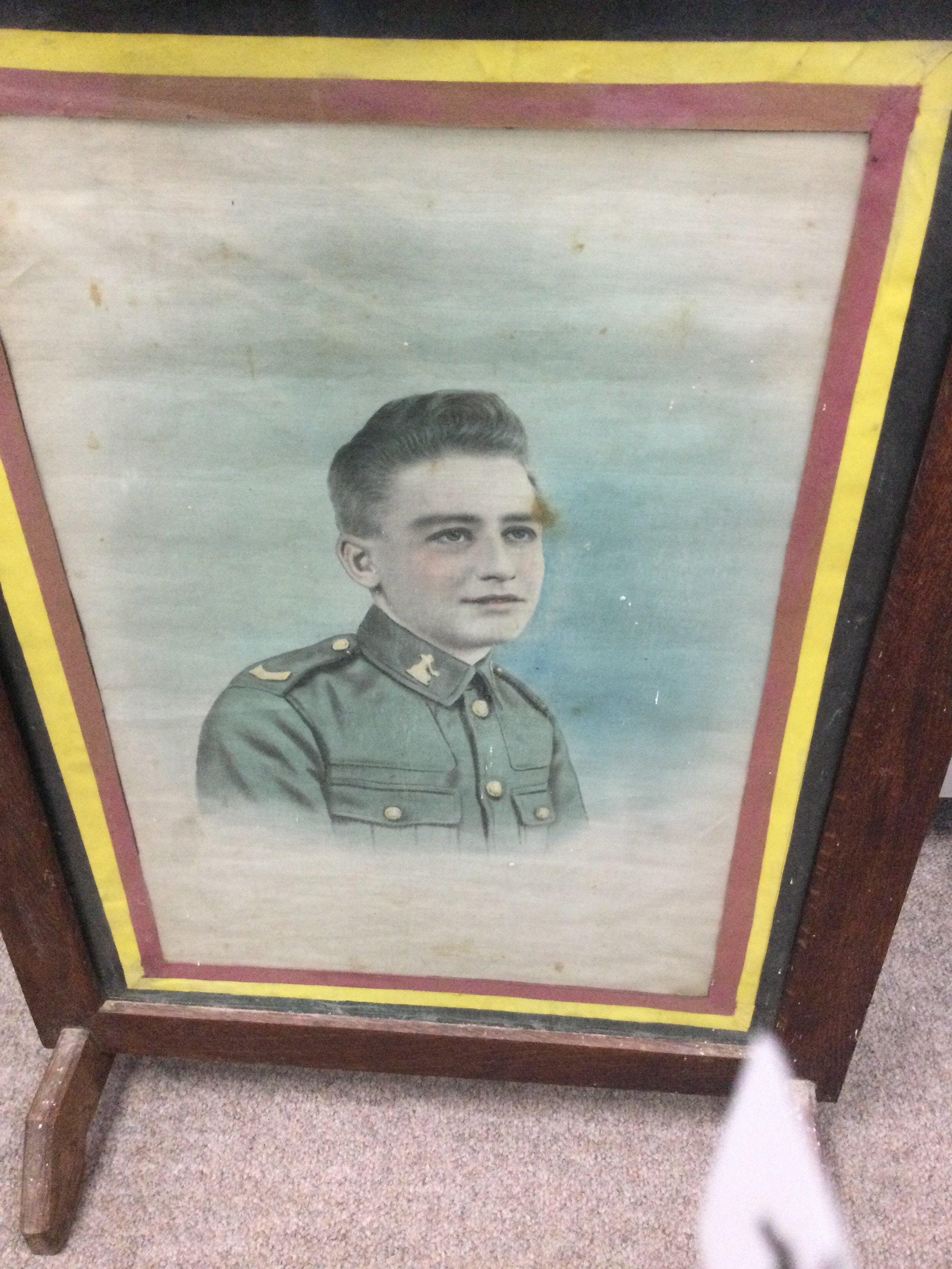 A fire screen inset with a portrait of Walter Sidney Tibrook the Norfolk Regiment.