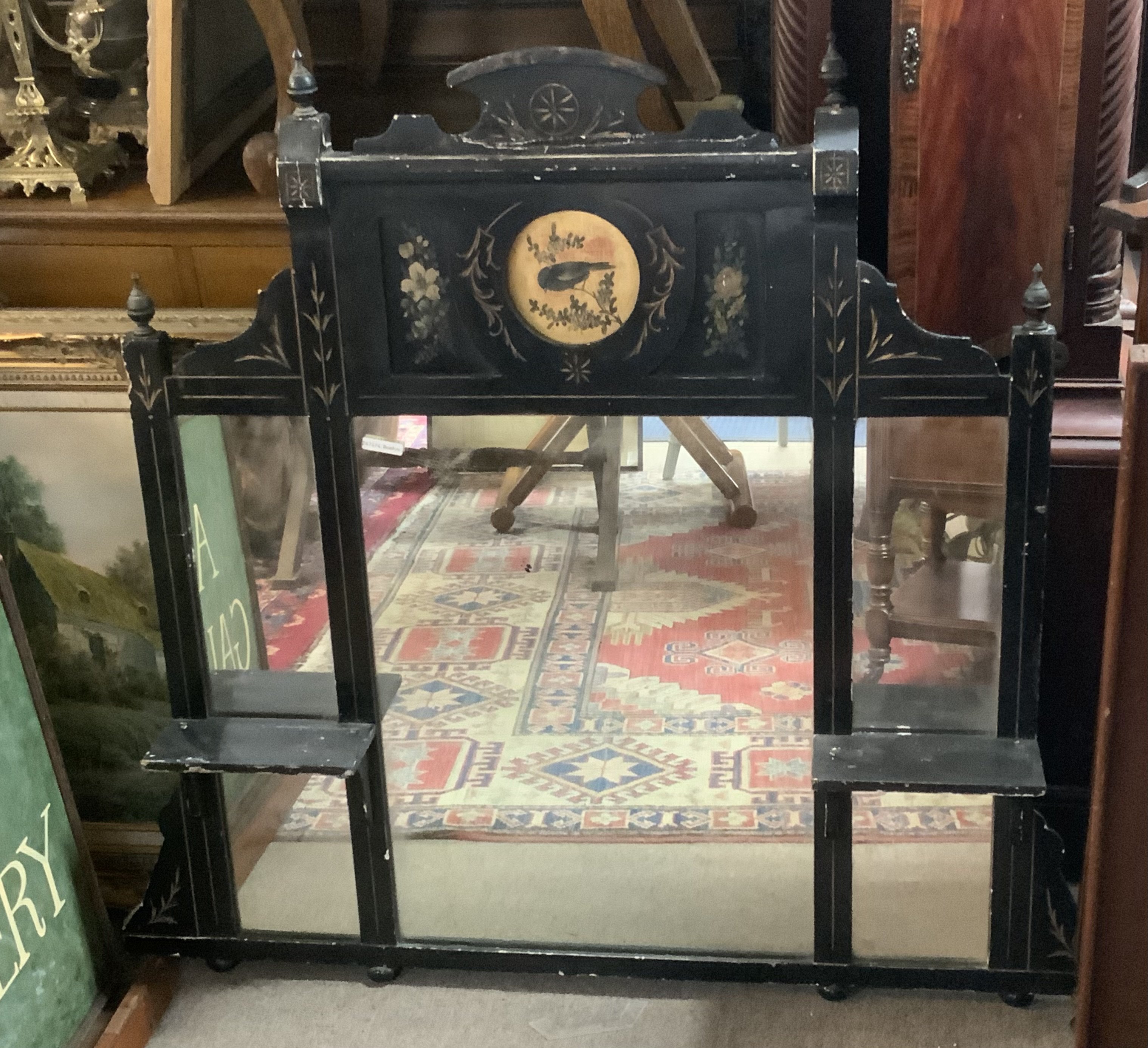 A Victorian ebonized and hand painted over mantle mirror. 107cm x 100cm.