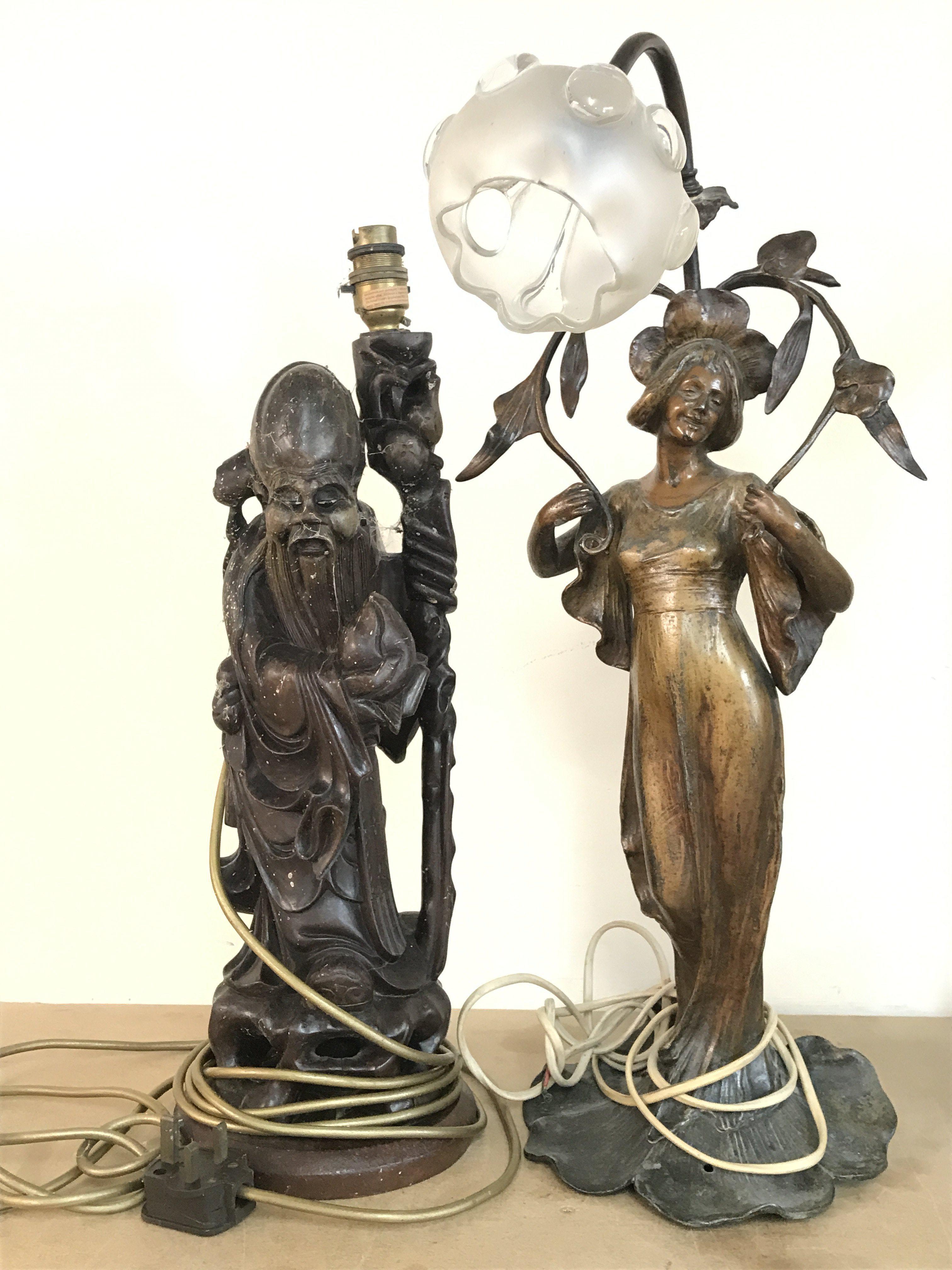 An Art Nouveau style simulated bronze lady figure lamp and a Chinese wooden carved figure lamp. This lot cannot be posted