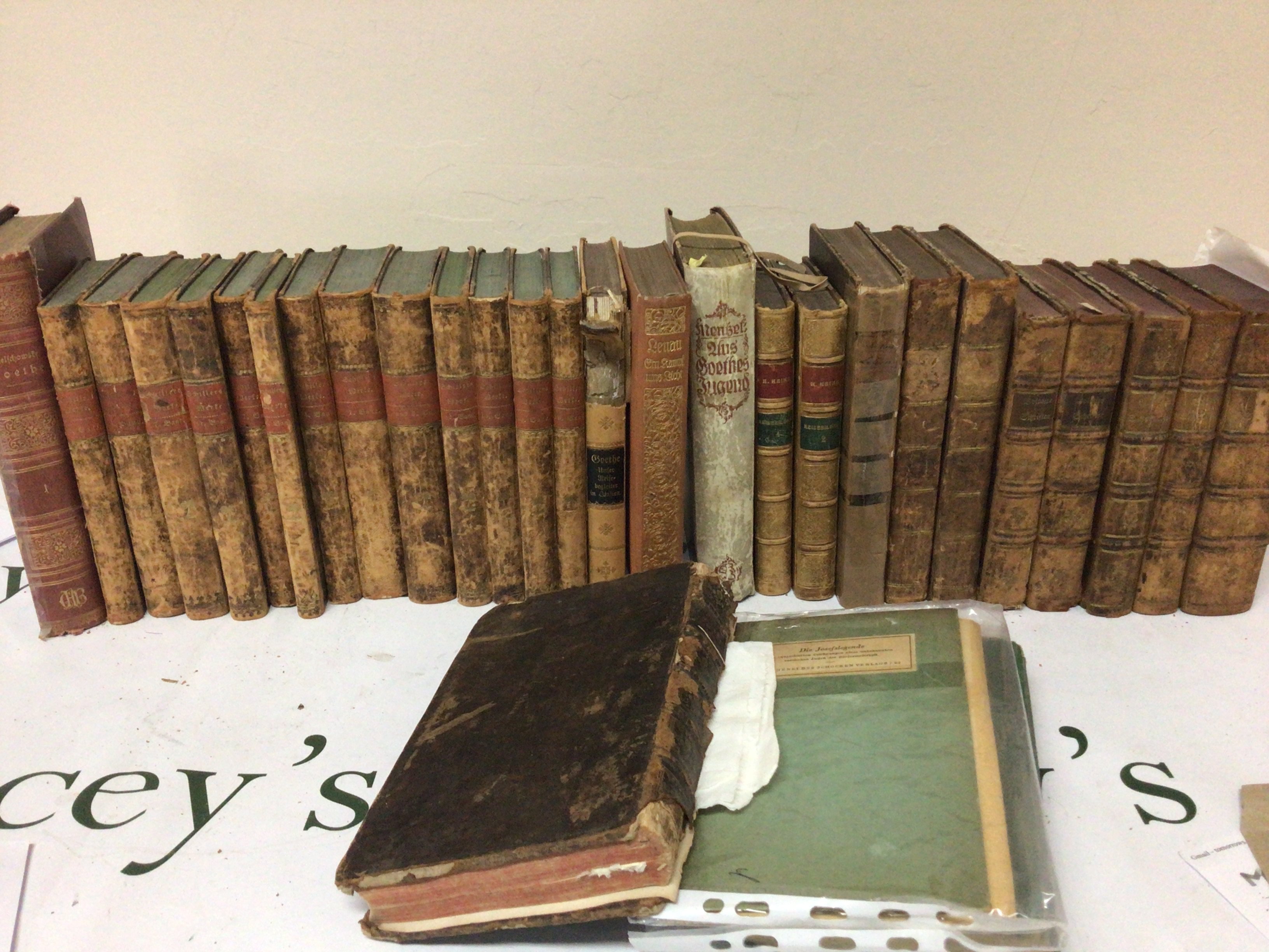 A collection of leather bound and half leather books early 19th century and later and a large illustrated antique bible.